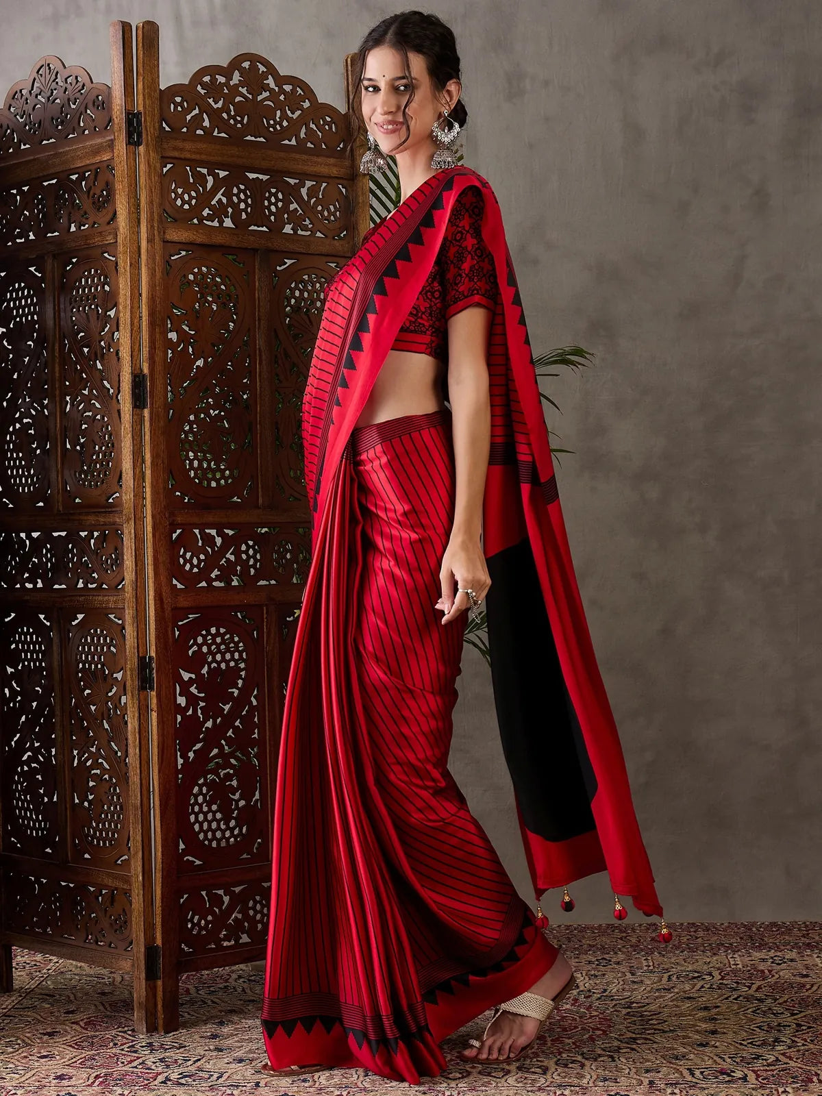 Tarani red semi modal satin saree side view highlighting graceful drape and pallu