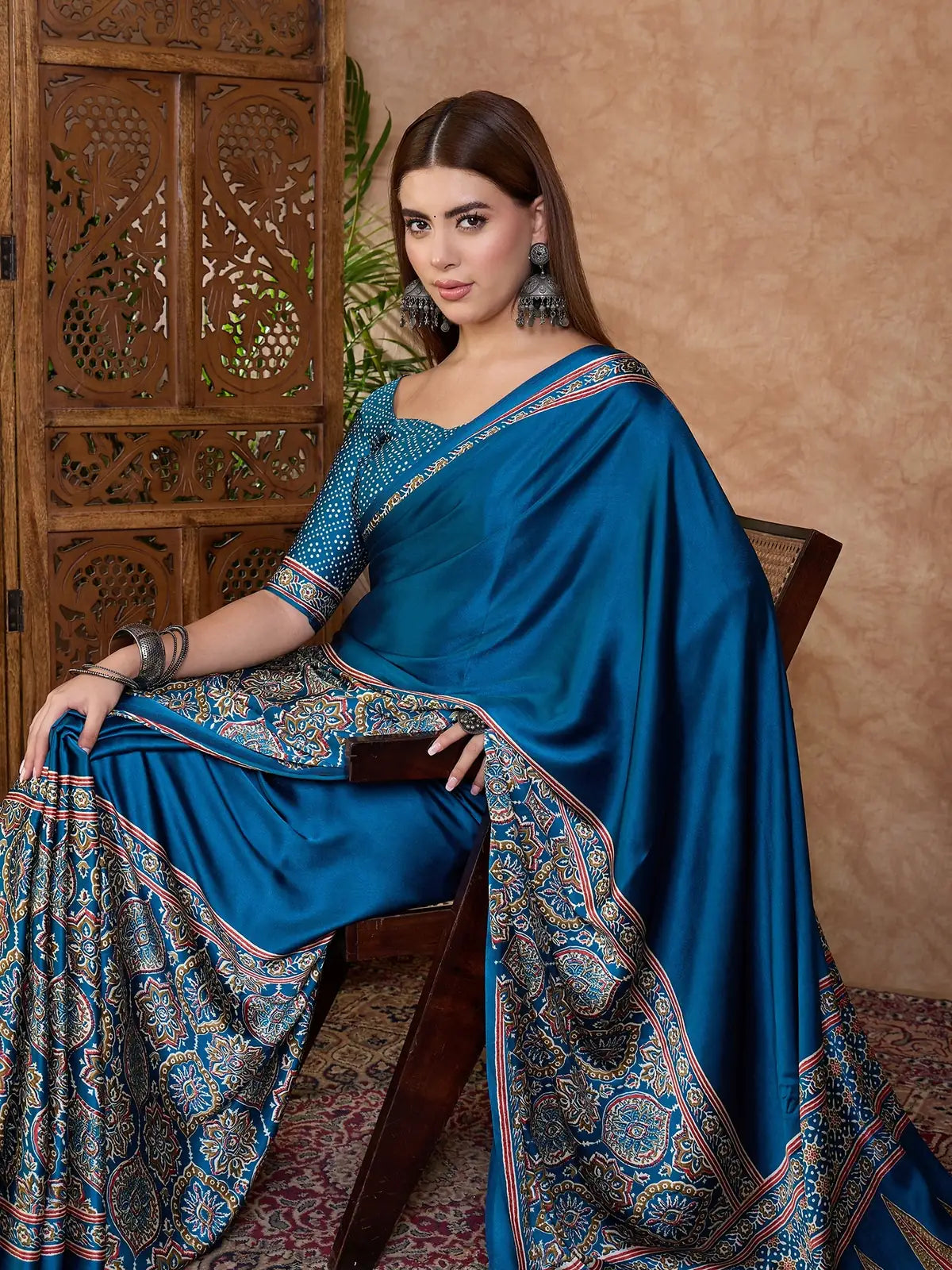 Tarani Fulrani teal semi modal satin saree seated side view with border details