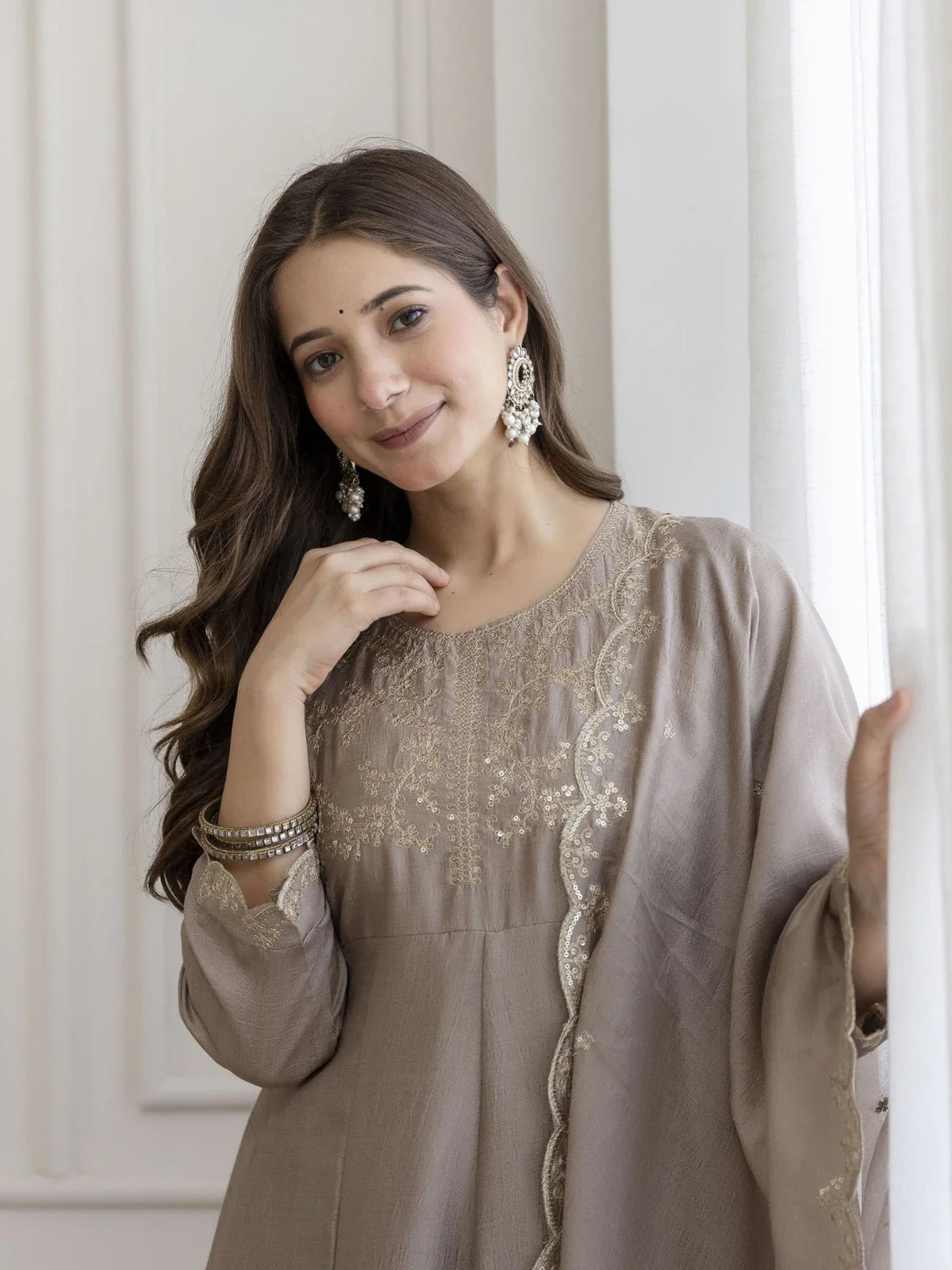 Tarani beige silk dress closeup showing neckline embroidery and three-quarter sleeves