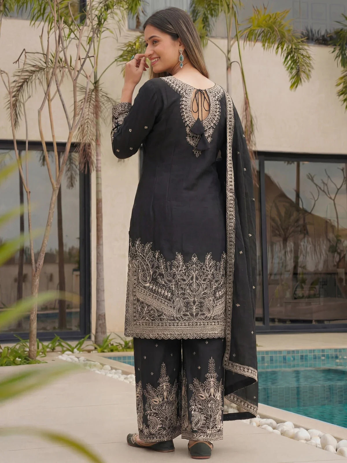 Tarani black embroidered back view with tassel tie up and golden thread work