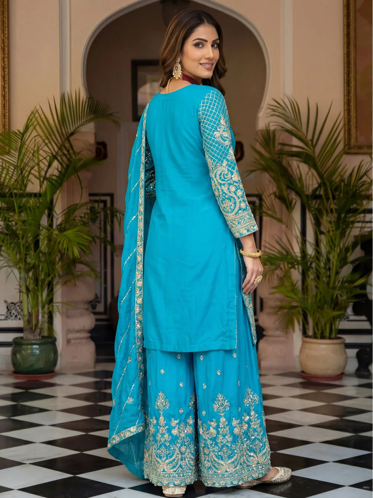 Tarani back view of blue embroidered silk kurti and sharara with zari work