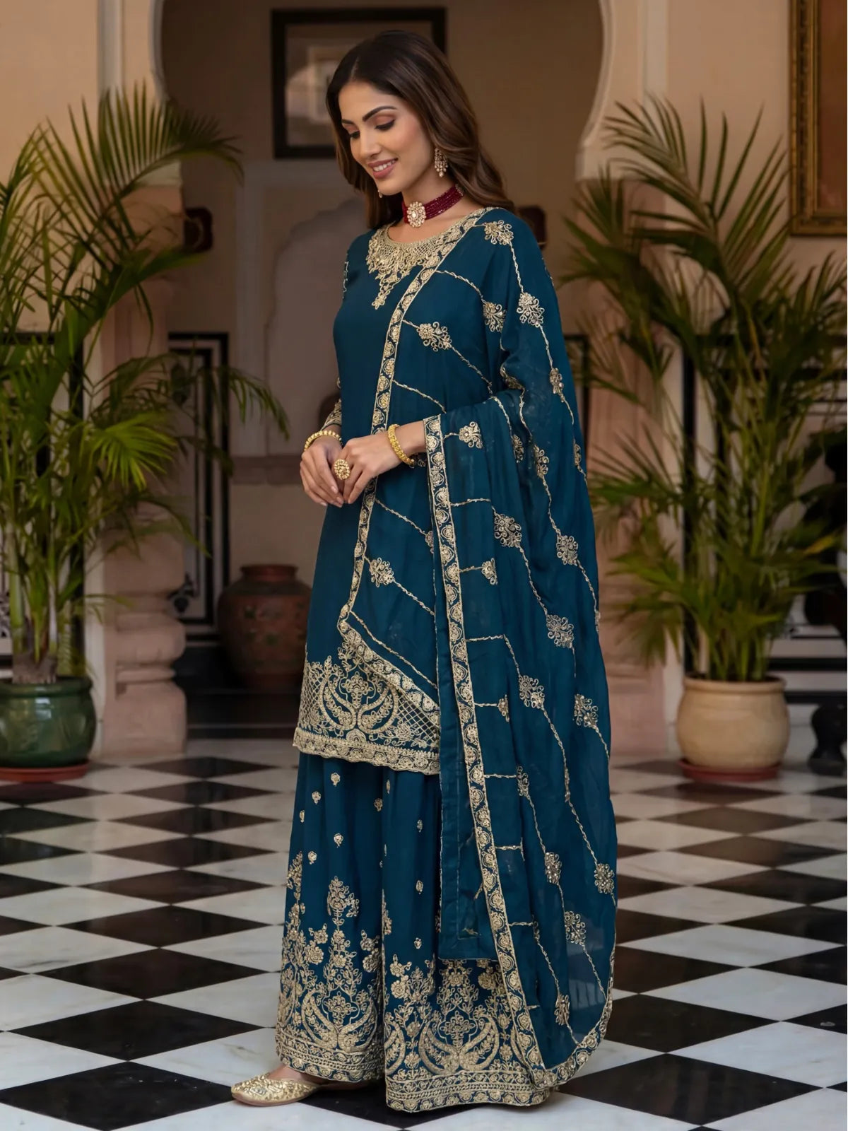 Tarani elegant green festive dress side view highlighting zari work and dupatta fall