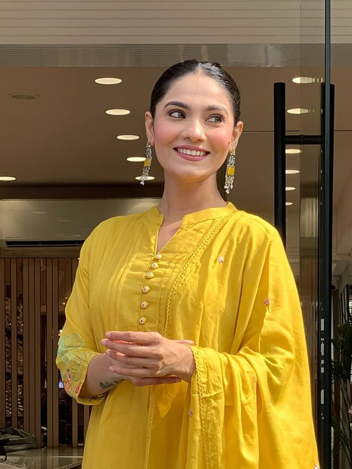 Tarani yellow silk festive dress showing elegant neckline and sleeve embroidery