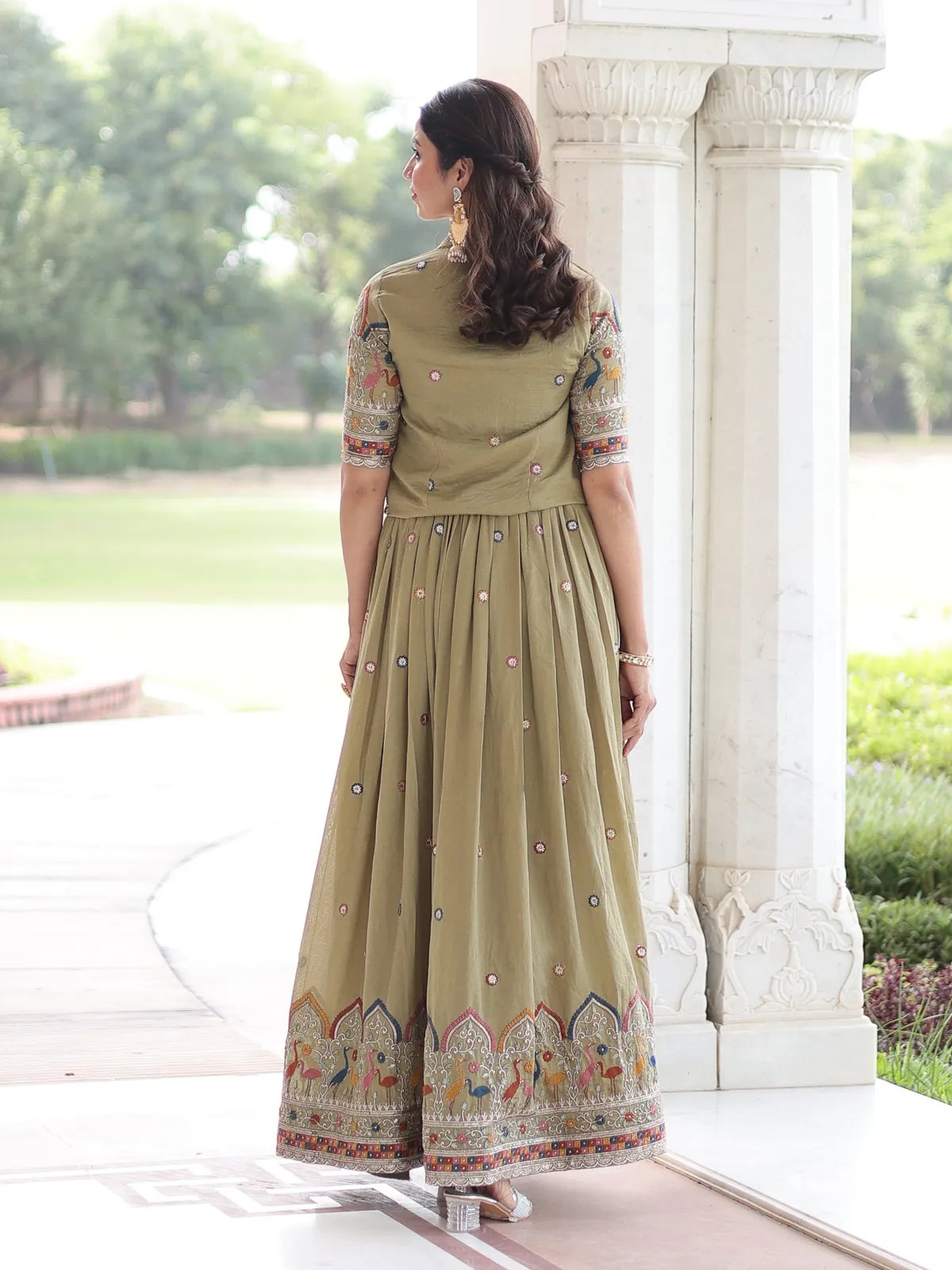 Tarani designer green silk gown back view highlighting embroidery on koti and pleated flow