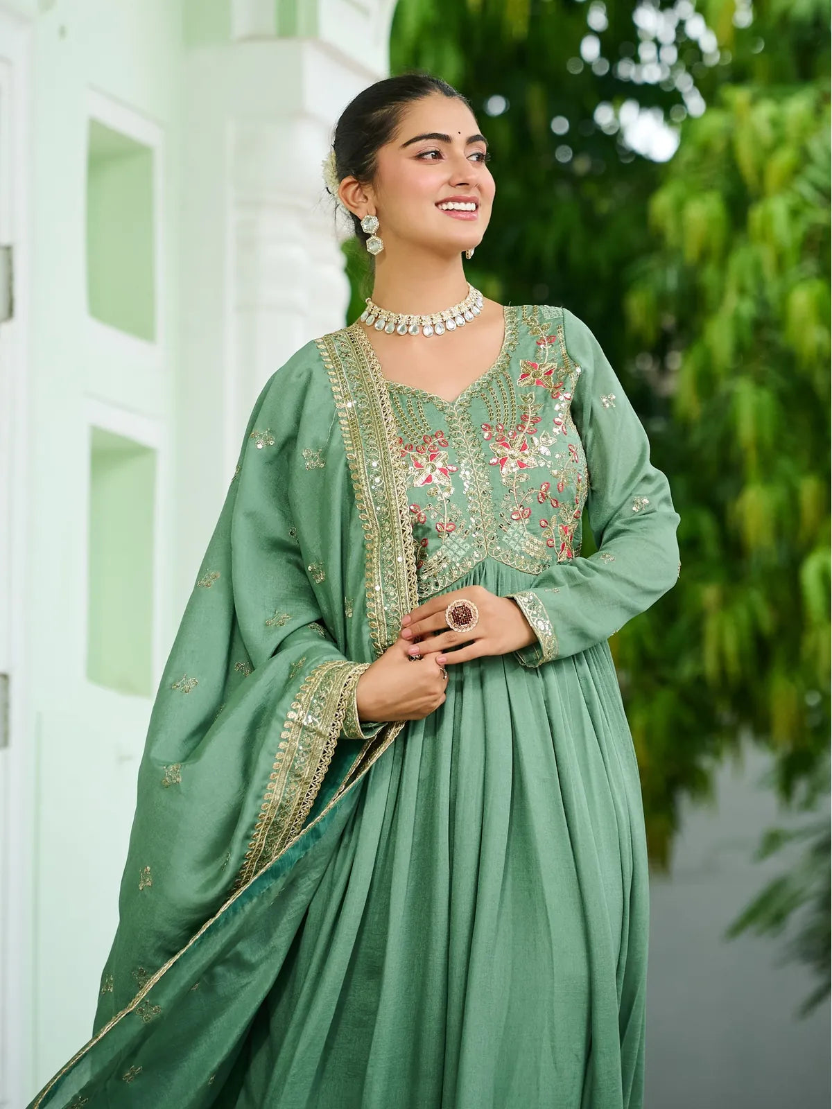Tarani green silk gown close-up with designer neckline and zari embroidery