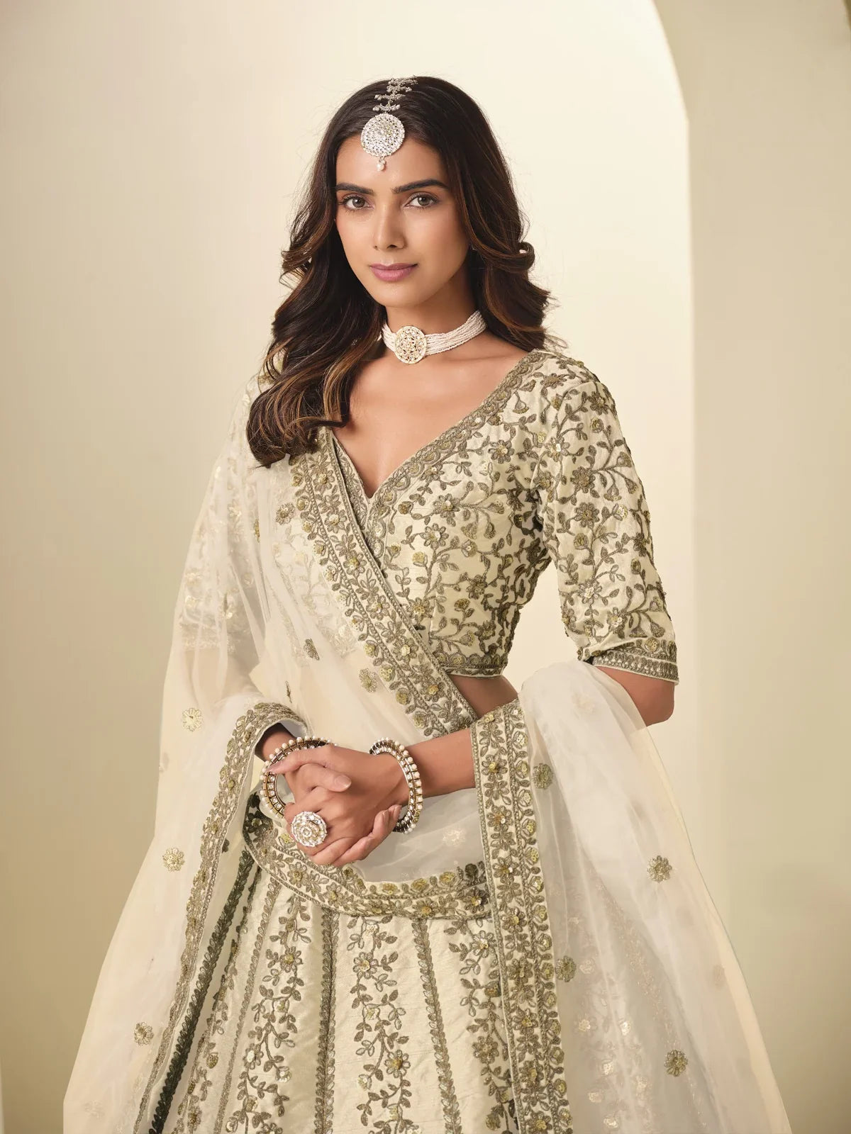 Tarani beige silk lehenga upper body view showing neckline and half sleeve blouse embroidery