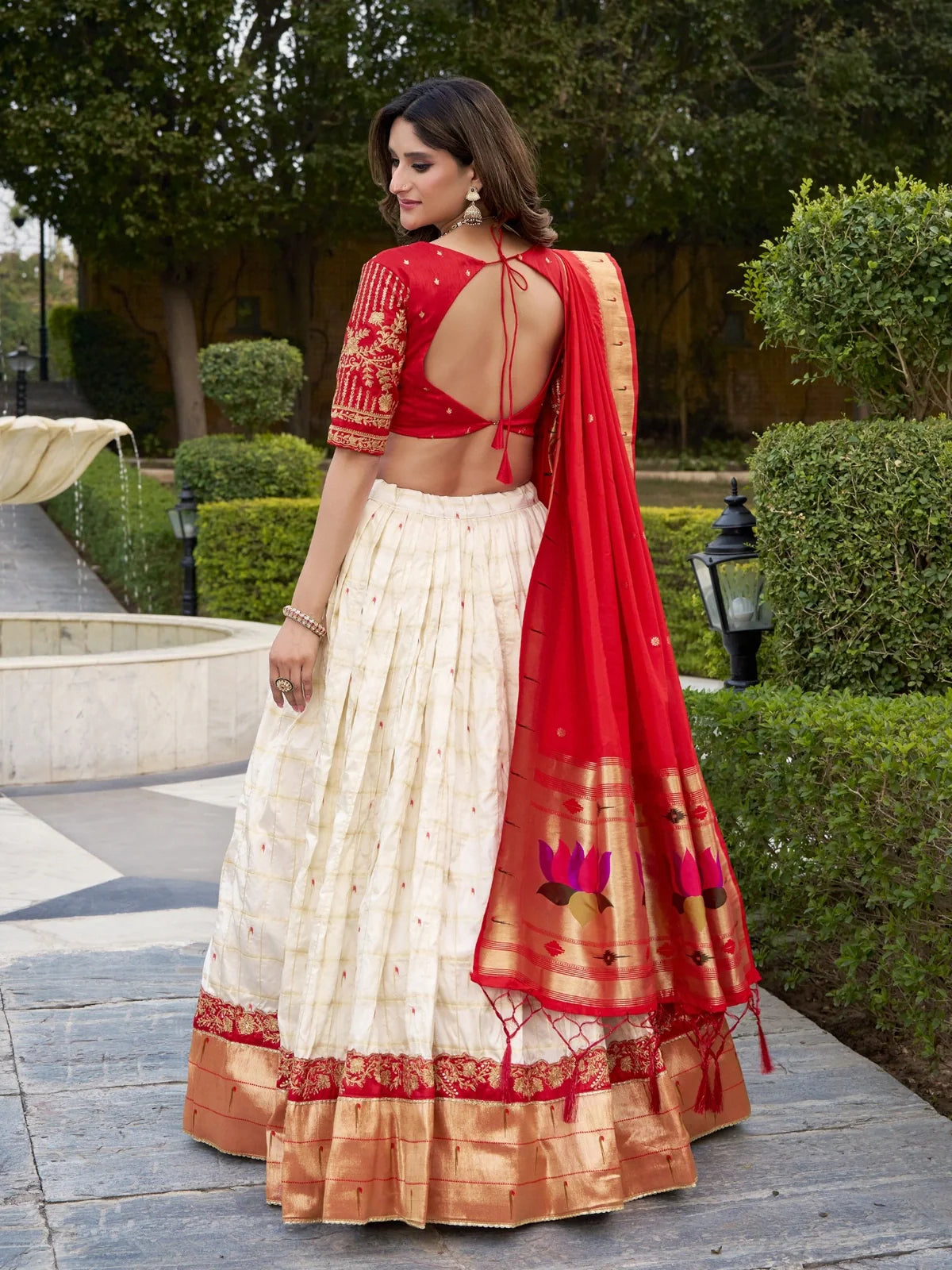 Tarani back view of red tie-back blouse with paithani dupatta and cream lehenga