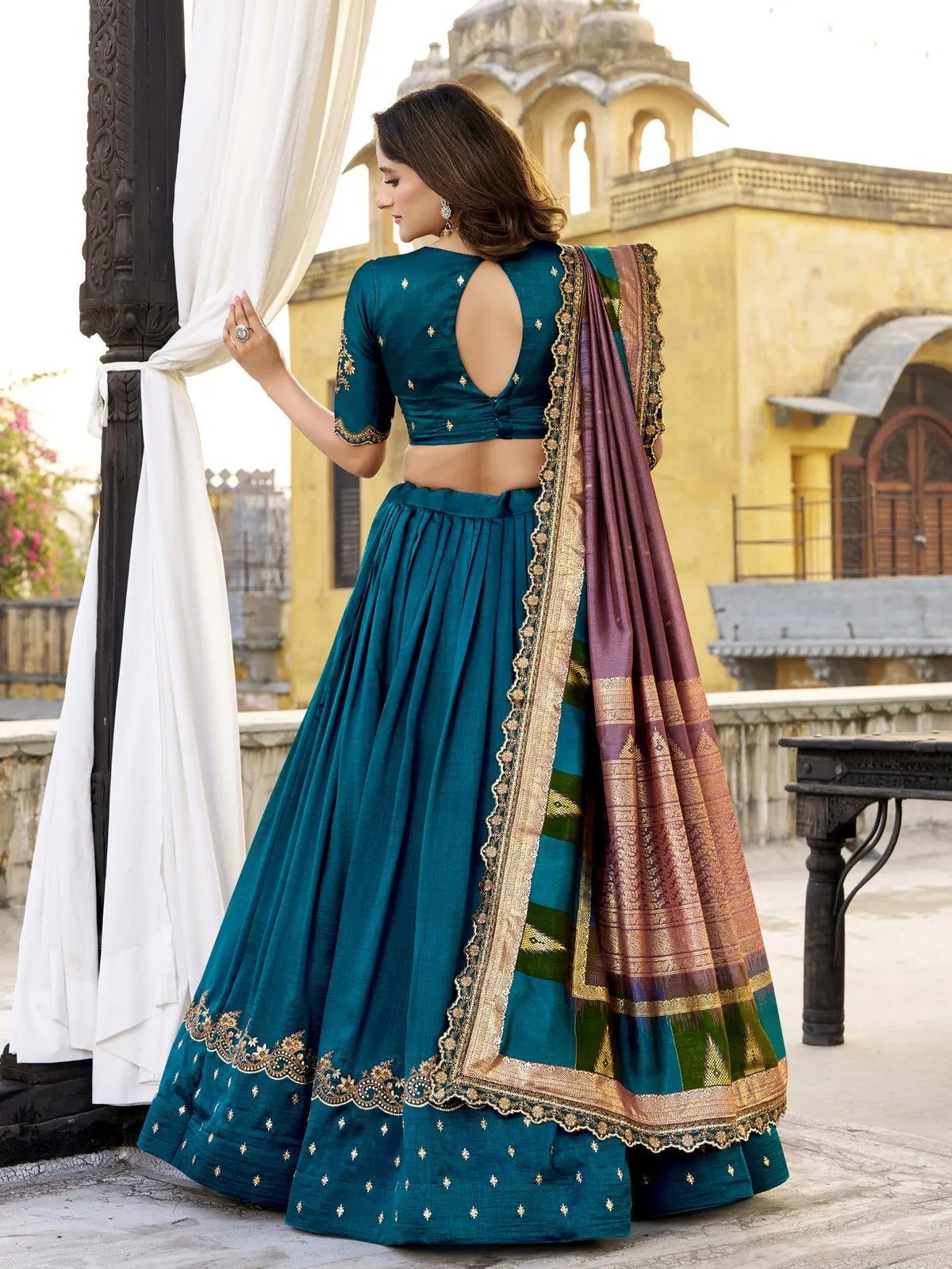 Tarani green silk lehenga with keyhole back blouse design and detailed dupatta, back full view