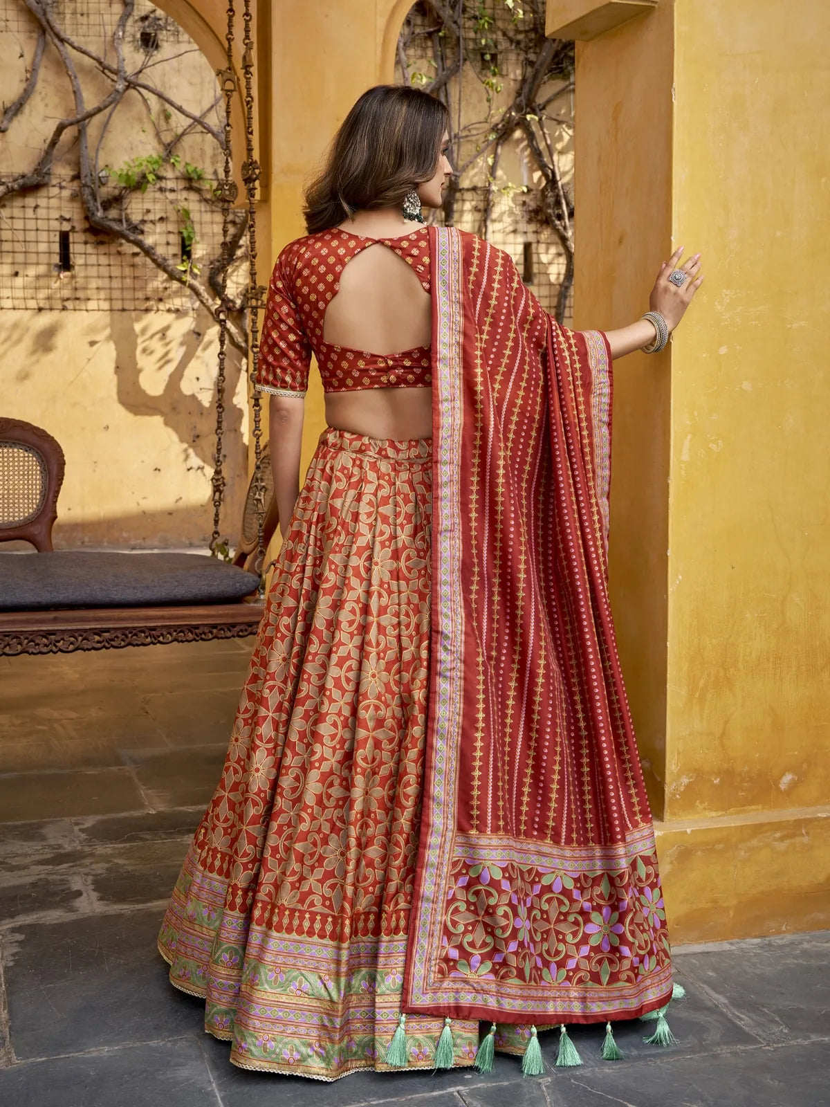 Tarani back blouse view showing deep-cut pattern with matching maroon silk lehenga