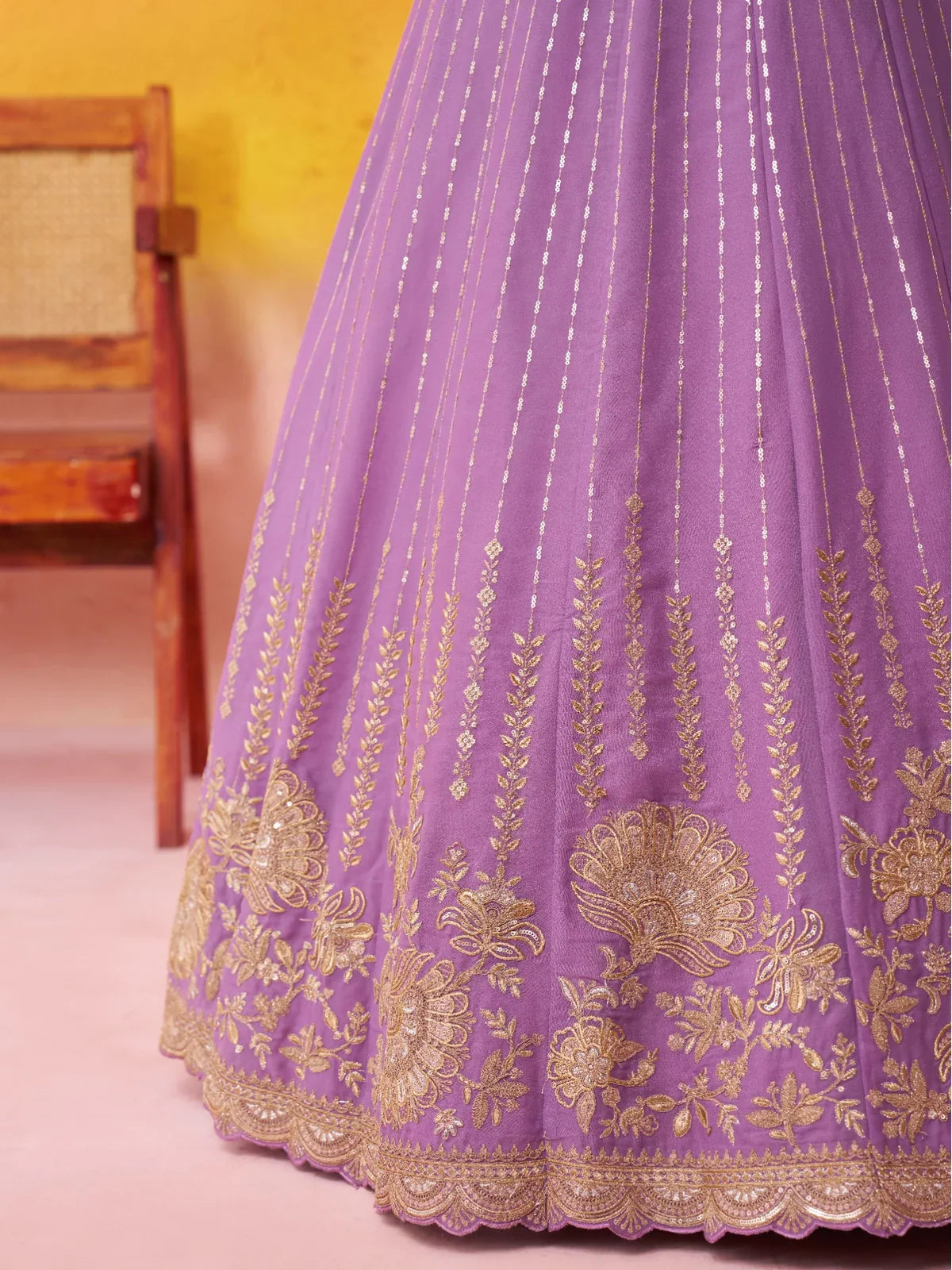 Close-up of Tarani mauve lehenga skirt golden embroidery motifs and scallop border