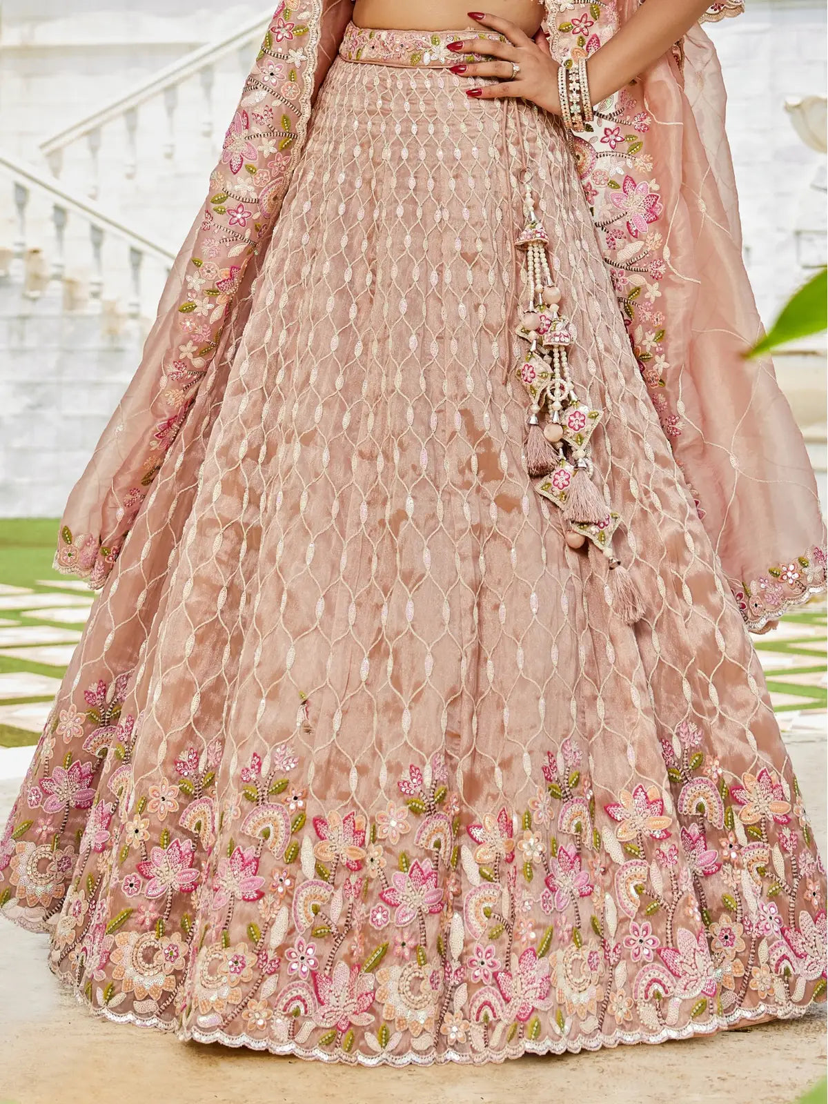 Tarani peach satin silk lehenga closeup view highlighting embroidery and border