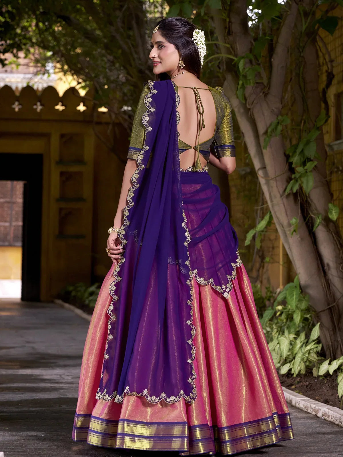 Tarani lehenga back view showing deep back blouse with tie-up and scallop edge embroidered dupatta