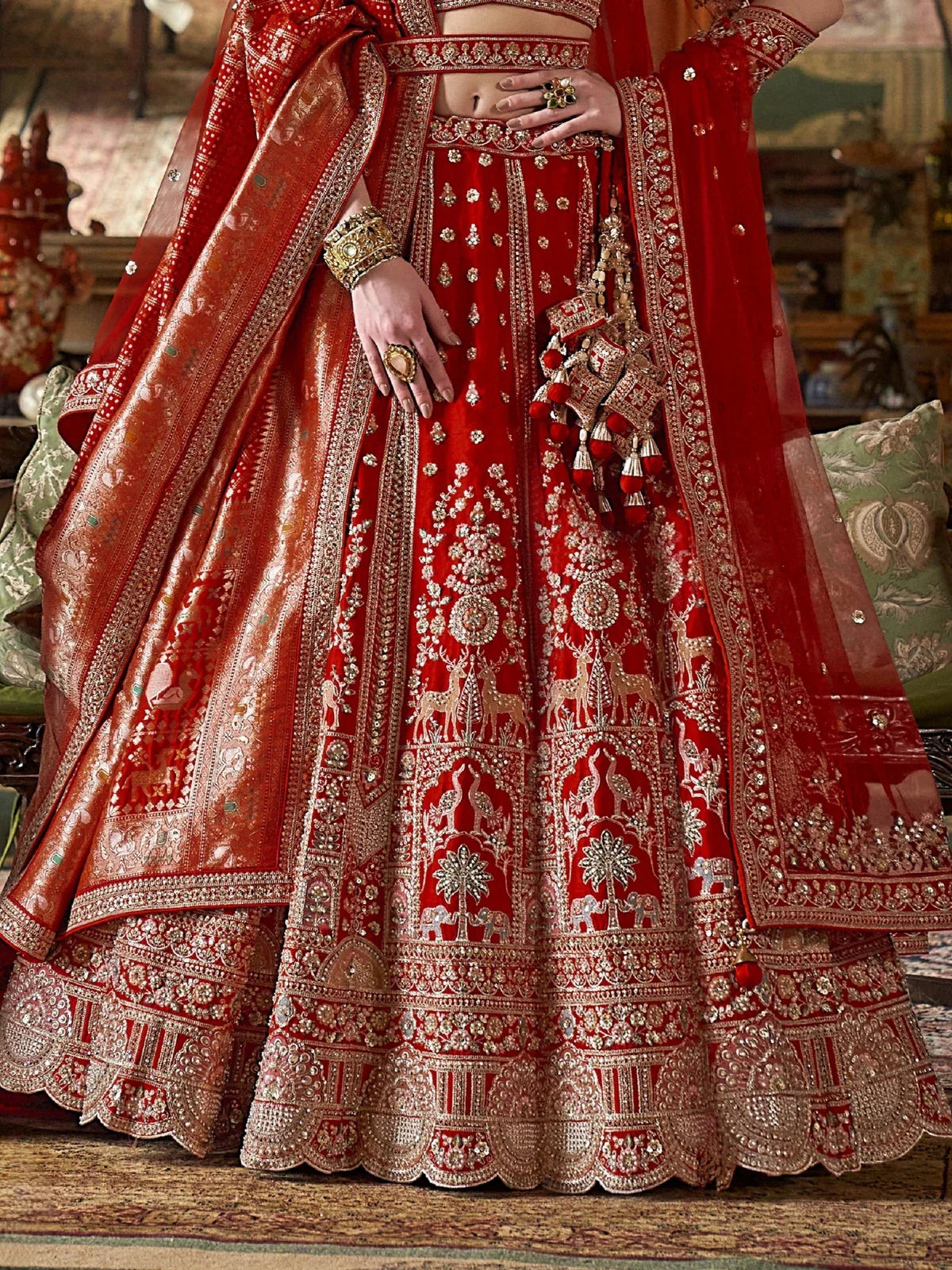 Tarani red silk bridal lehenga closeup view highlighting zari embroidery and fabric detailing