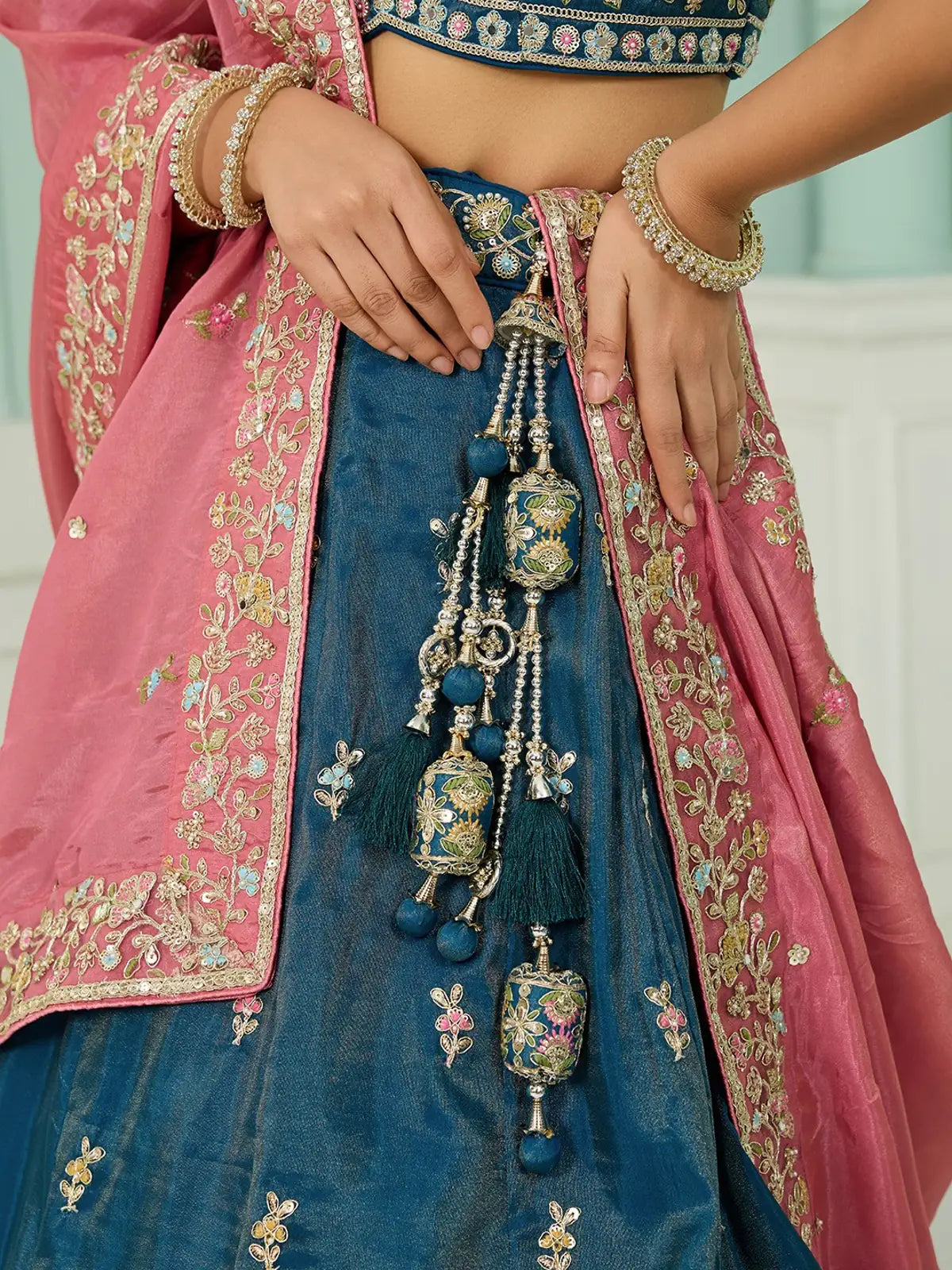 Tarani teal silk lehenga close-up detailing and tassels