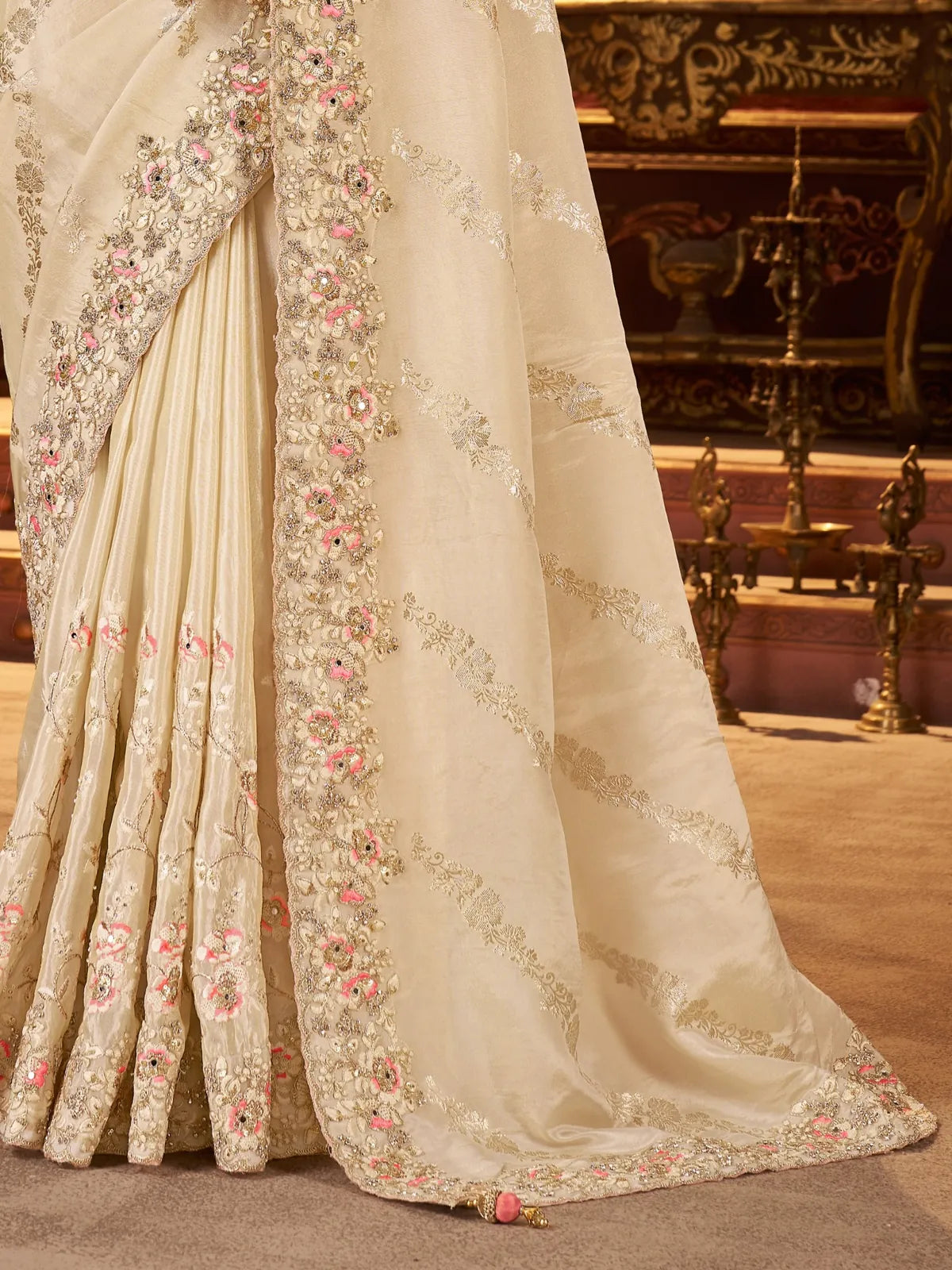 Tarani pallu close-up of beige silk saree with floral zari embroidery and heavy latkan