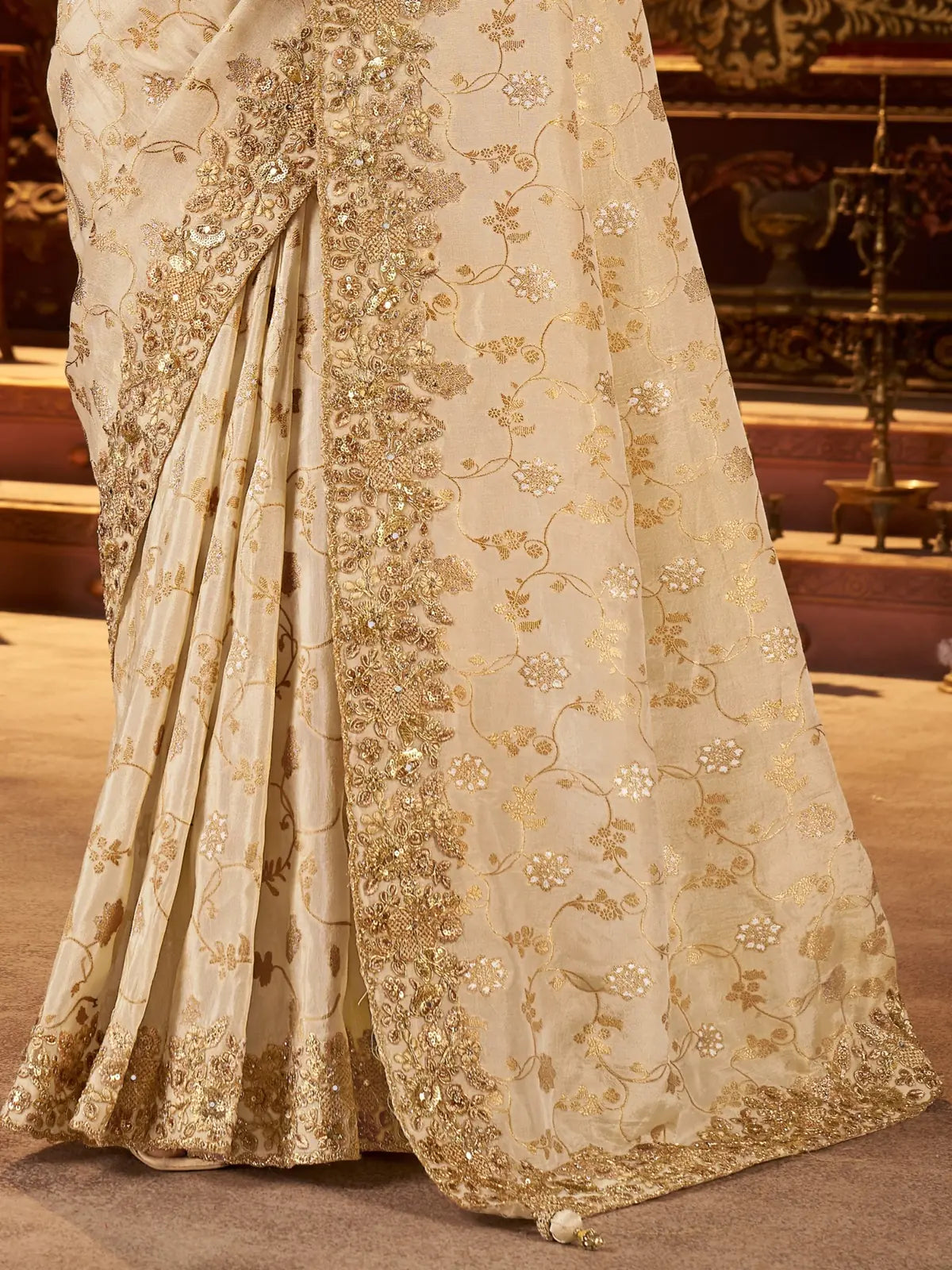 Tarani pallu closeup of beige saree with heavy zari embroidery and latkan finish