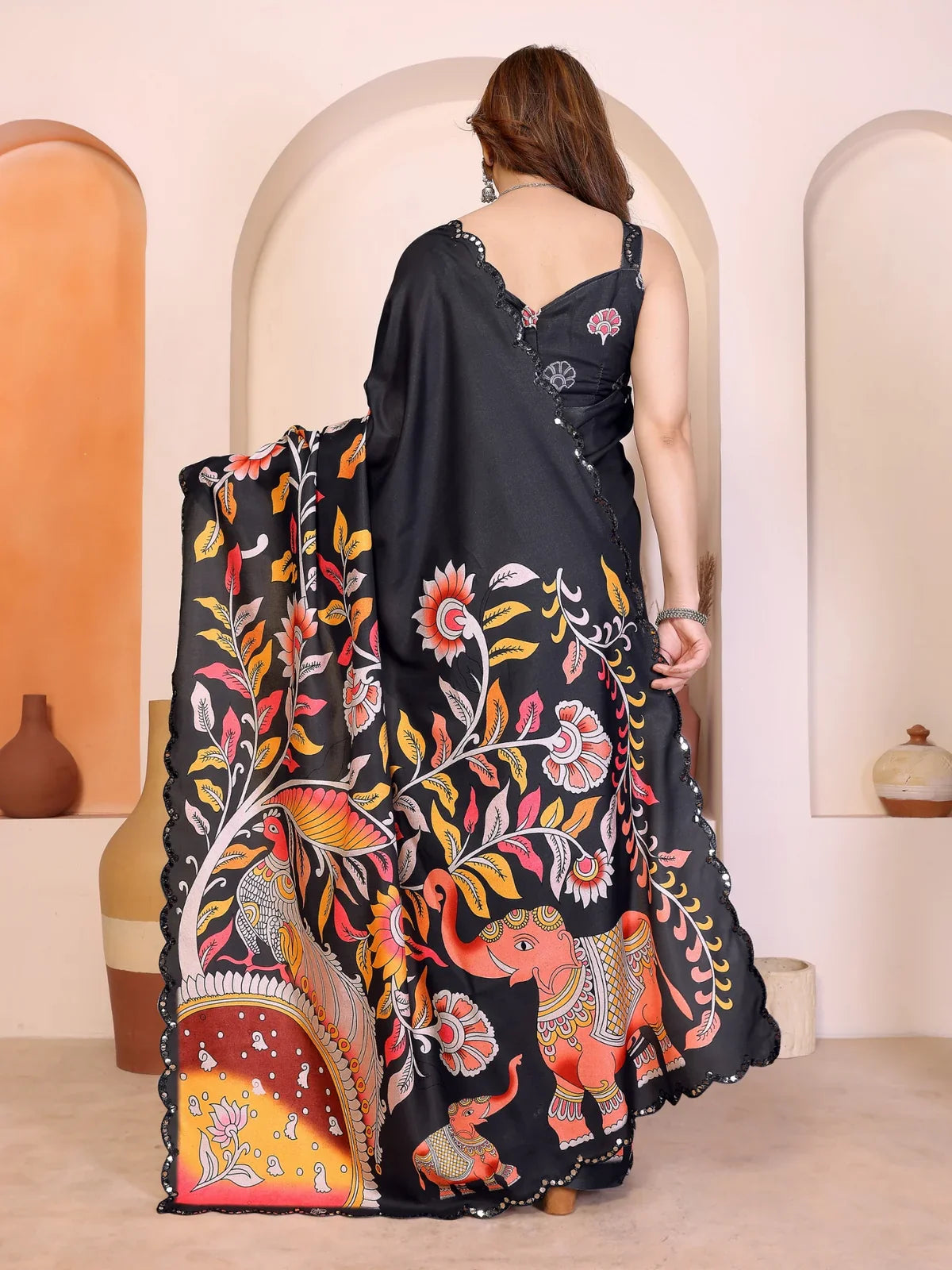 Tarani black manipuri silk saree back view highlighting full drape and traditional artwork