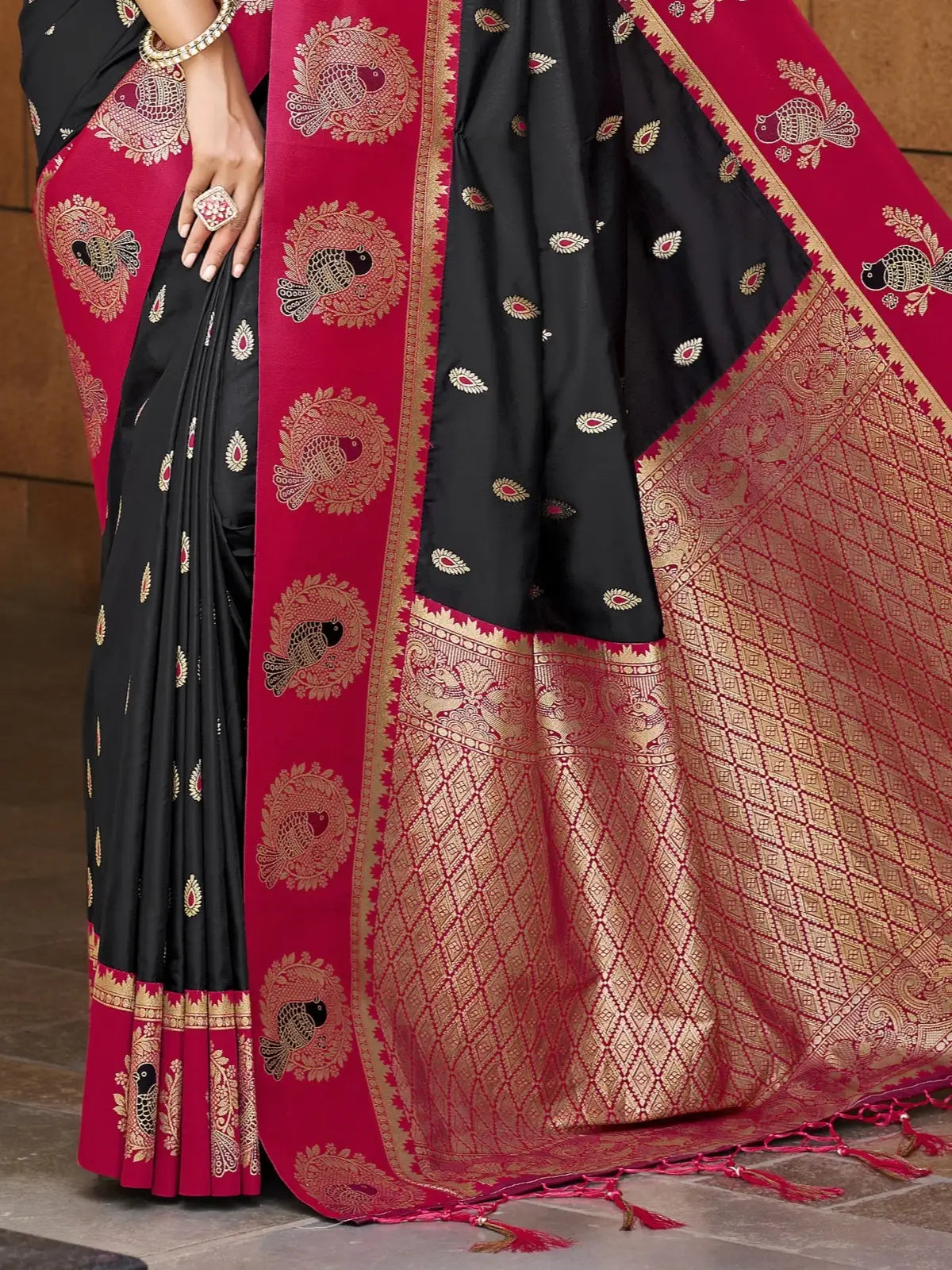 Tarani black silk saree pallu close view with rich zari weaving and contrast border