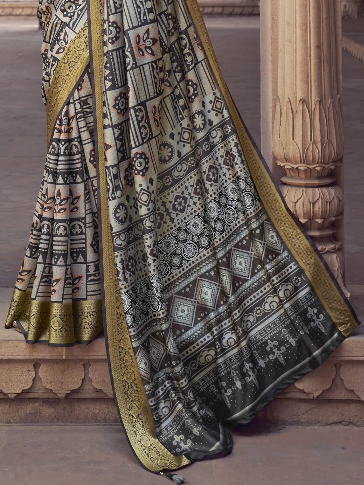 Tarani black silk saree pallu view with golden detailing and motifs
