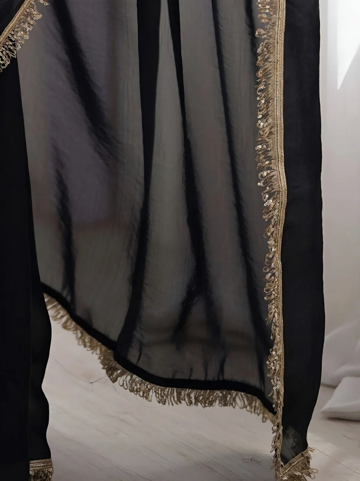 Tarani pallu and border view of soft black silk saree with shimmering golden sequin lace