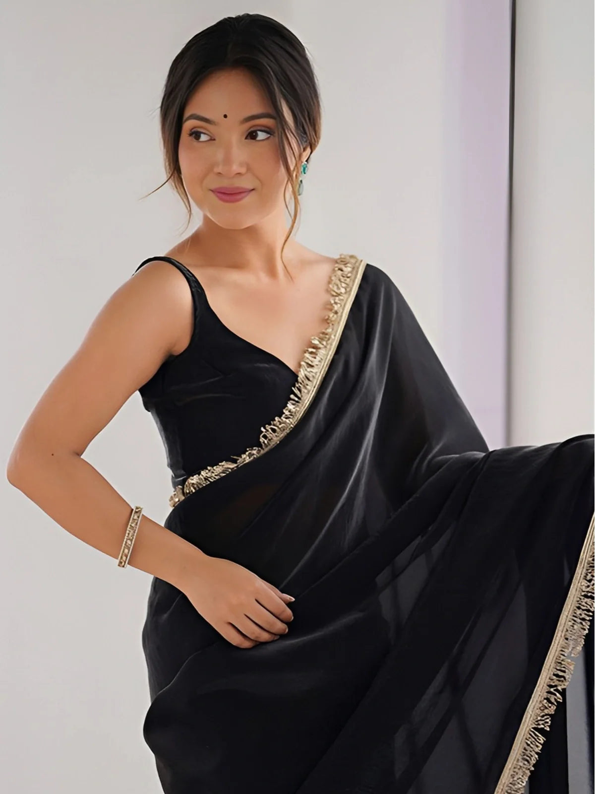 Tarani close-up upper body view of black silk saree with sequin lace border and elegant drape