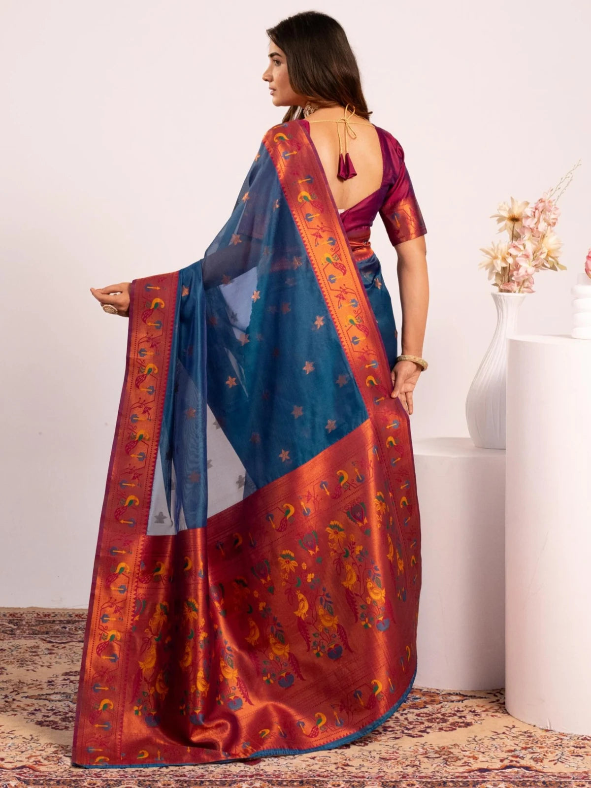 Tarani premium blue Paithani soft tissue silk saree back-view with zari woven border