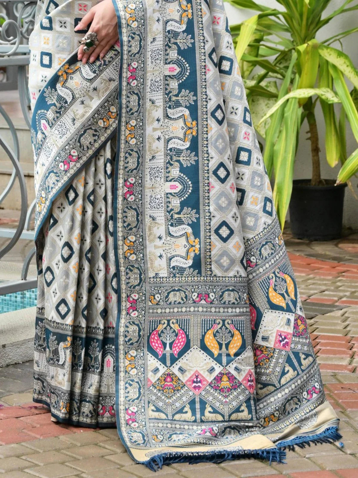 Tarani designer blue saree pallu with patola and ajrakh motifs in zari weaving shown in detail