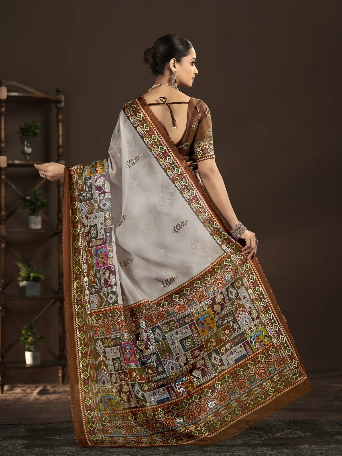 Tarani brown party wear saree full back view showing graceful pallu and blouse design