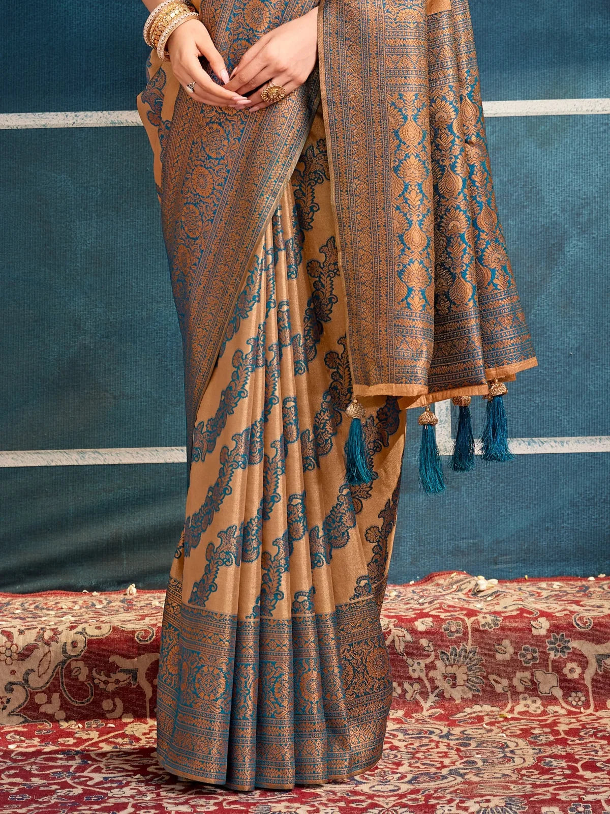 Tarani brown silk saree pallu close-up with rich blue woven border and tassels