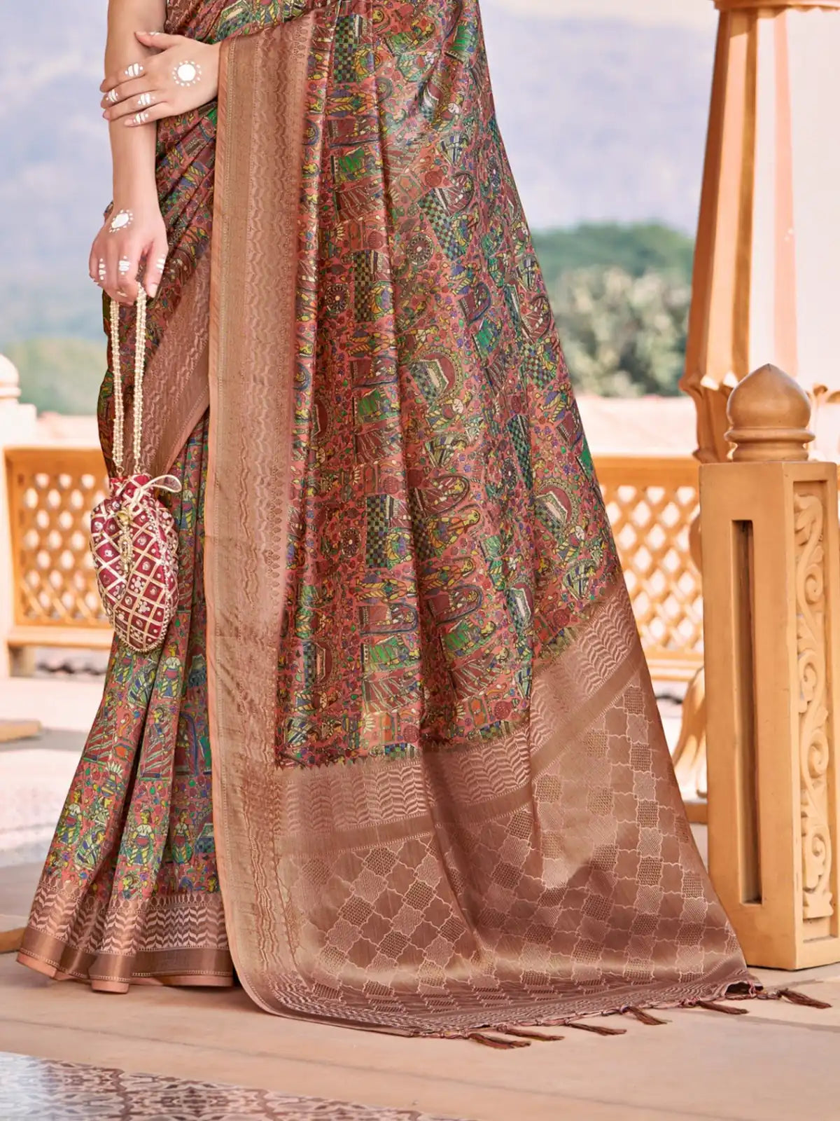 Tarani brown silk saree pallu view highlighting intricate woven multicolor design