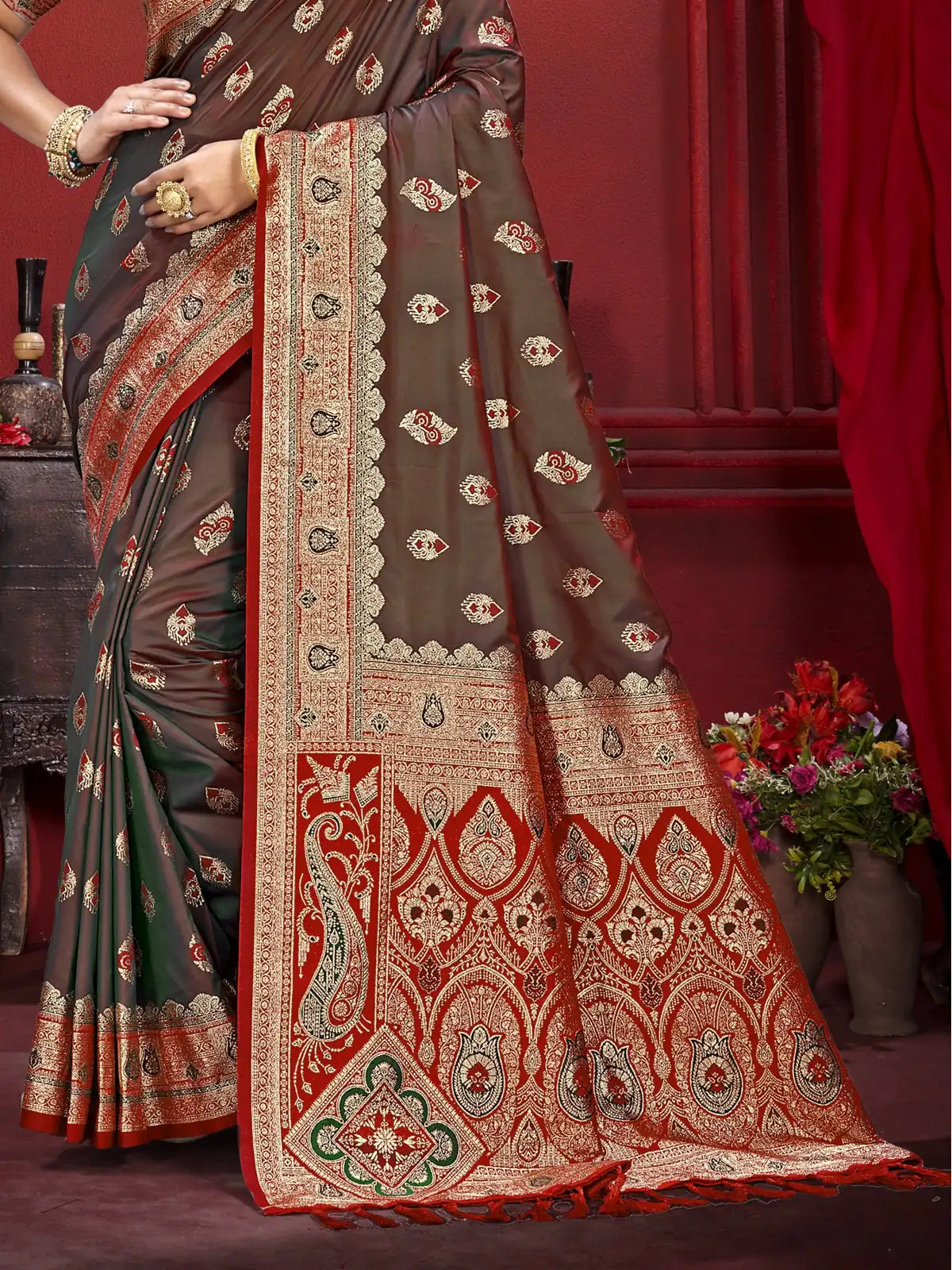 Tarani brown silk saree pallu closeup showing intricate red and gold woven design