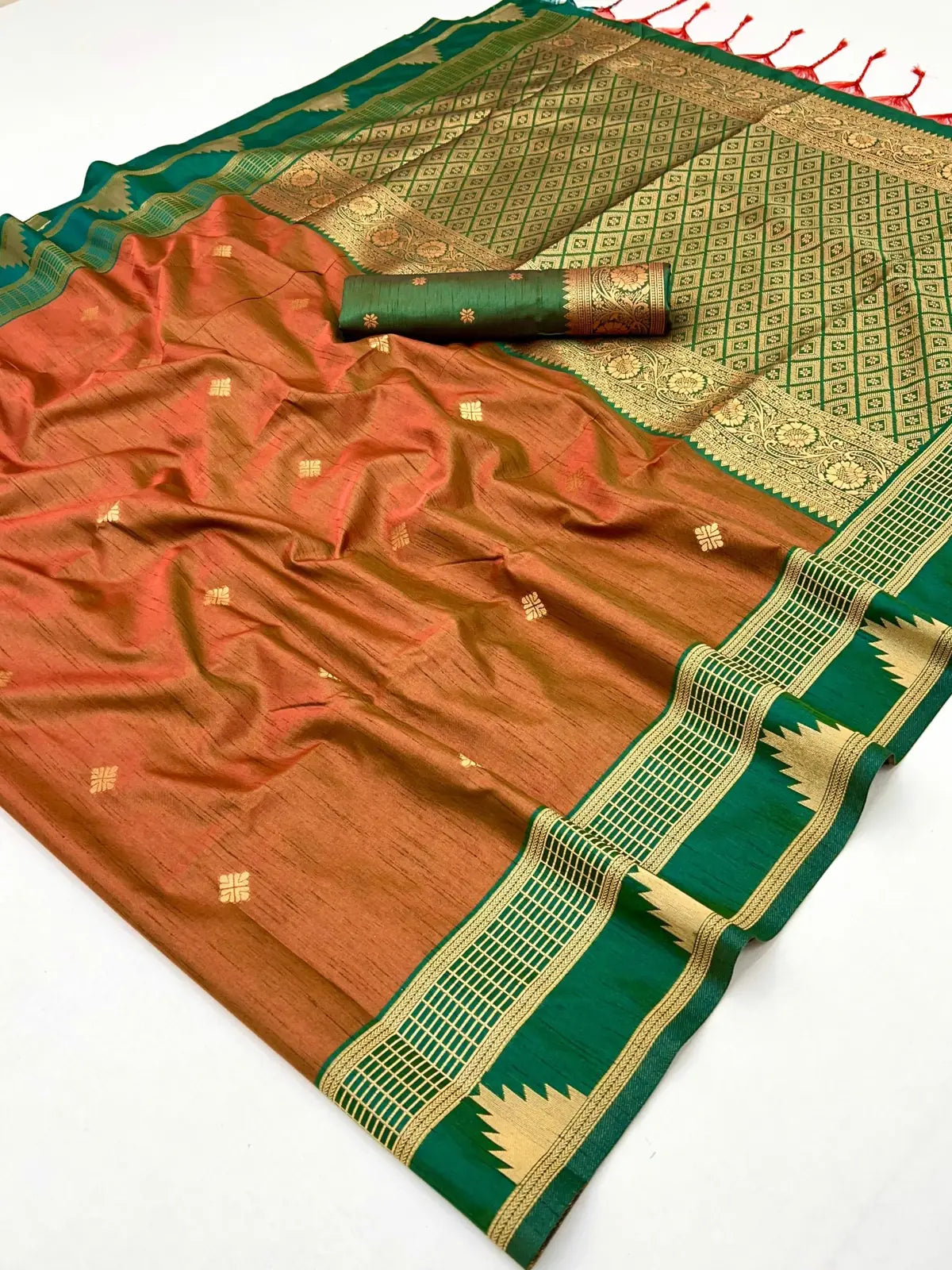 Tarani traditional silk saree laid out flat with attached green blouse and golden zari pallu