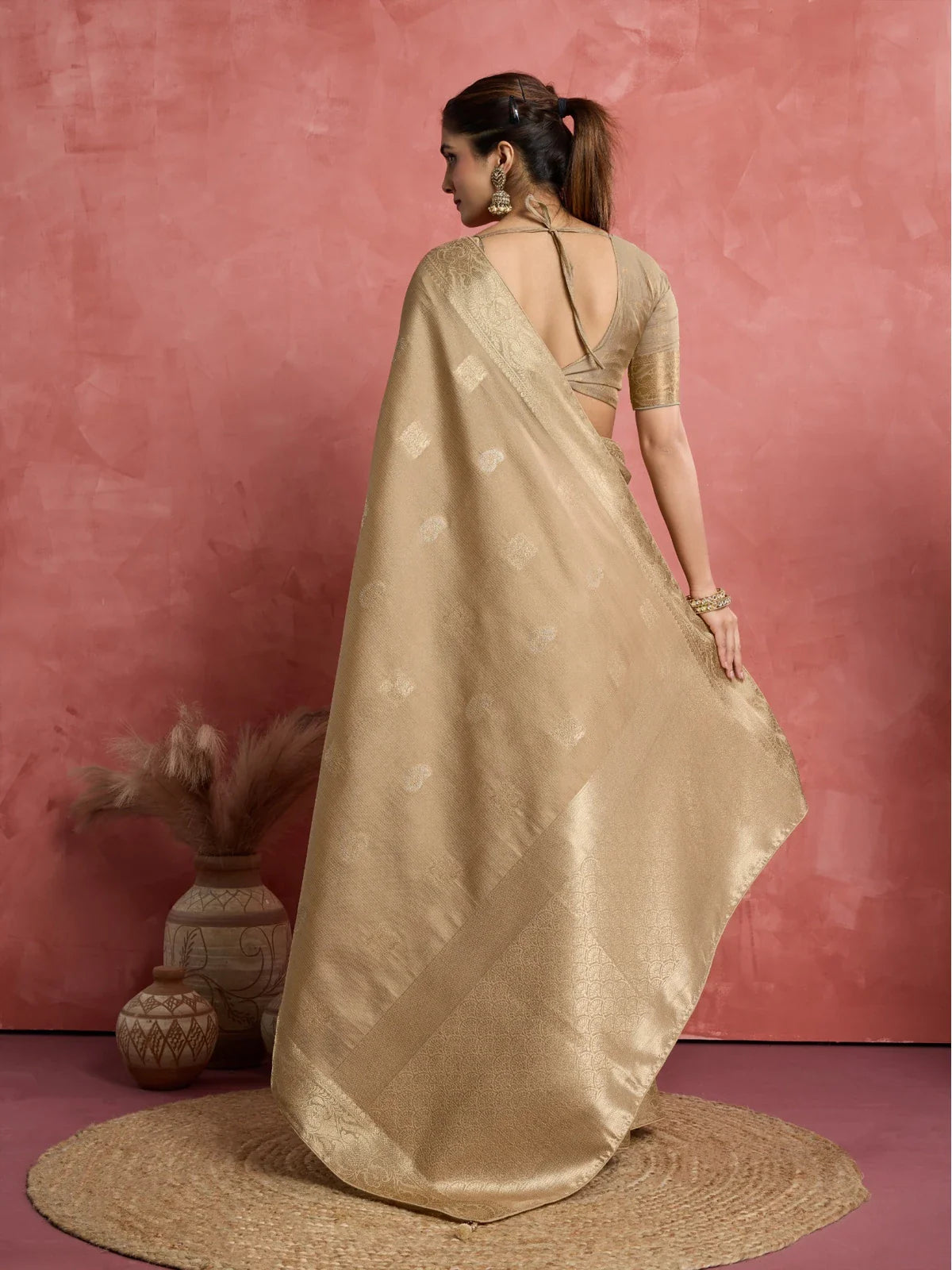Tarani golden silk saree back view with blouse tie-up design and flowing pallu