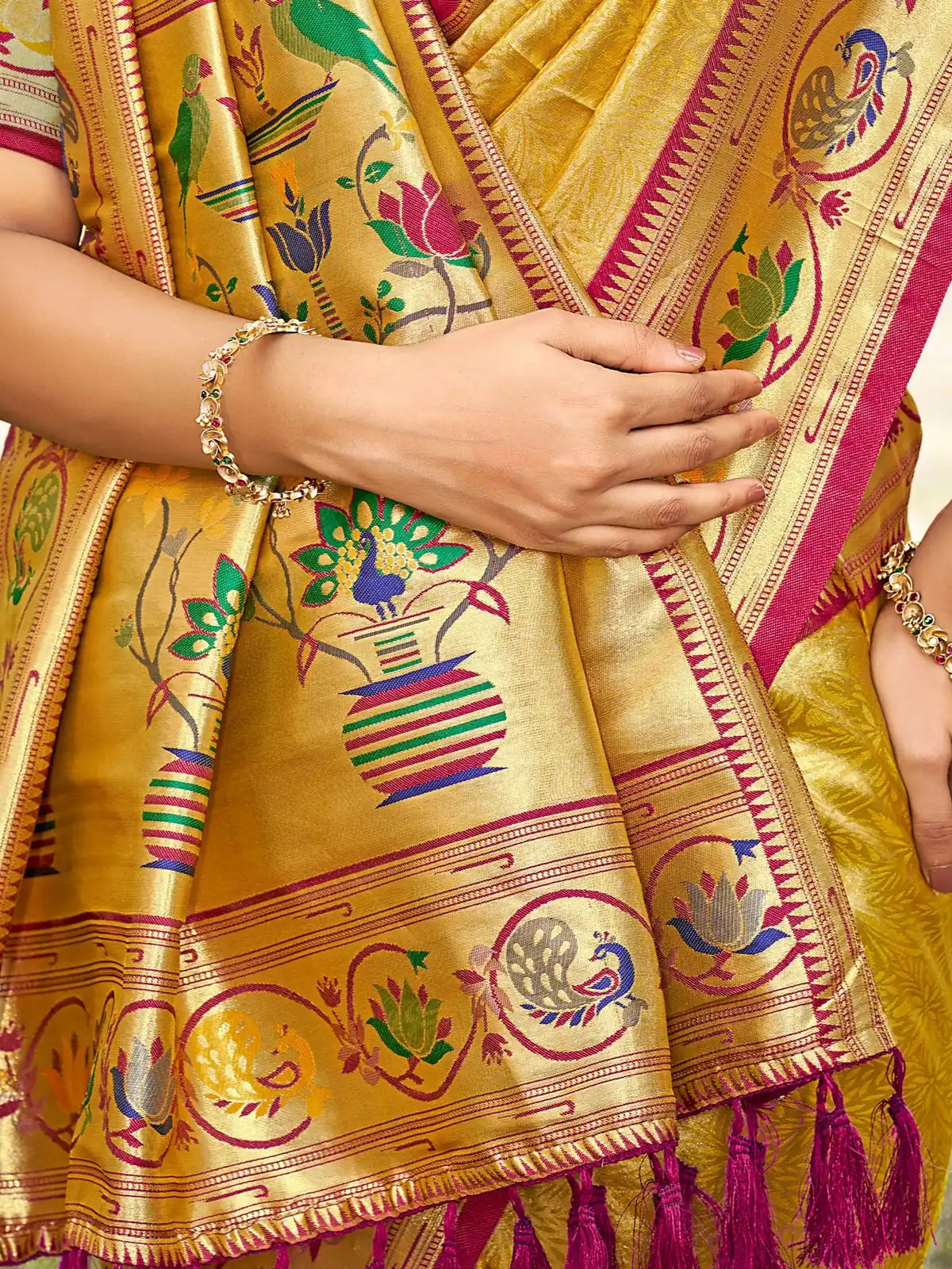 Tarani golden Kanjivaram silk saree closeup of Paithani weaving and tassels