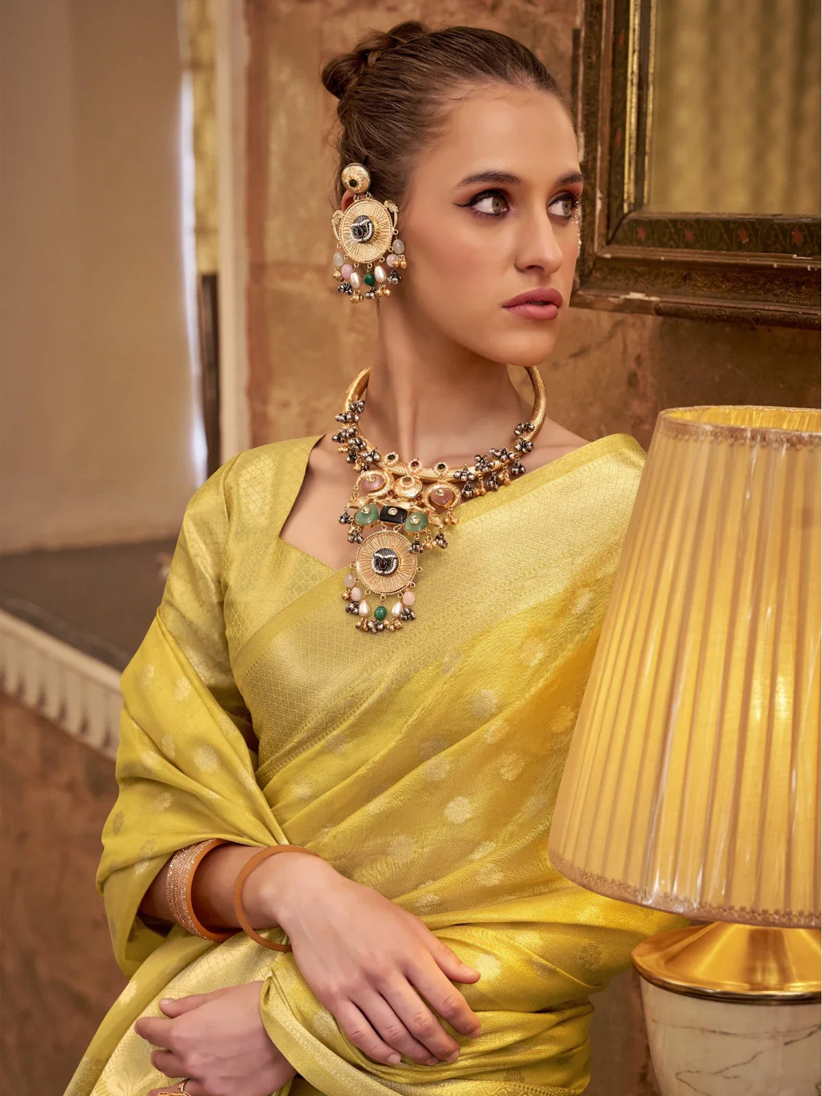 Tarani golden silk saree closeup view showing woven texture and subtle motifs