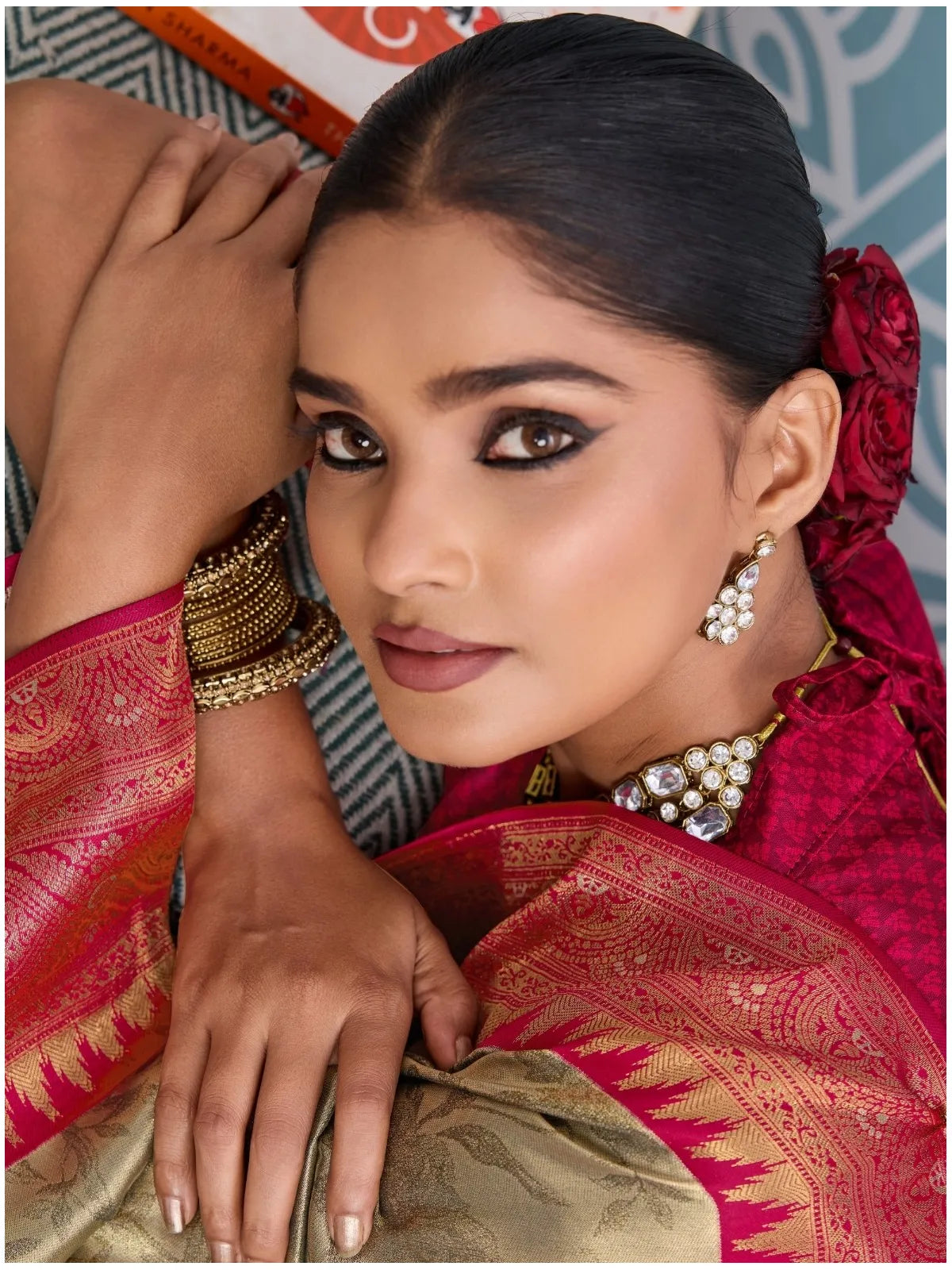 Tarani closeup view of golden silk saree with zari weaving and red border