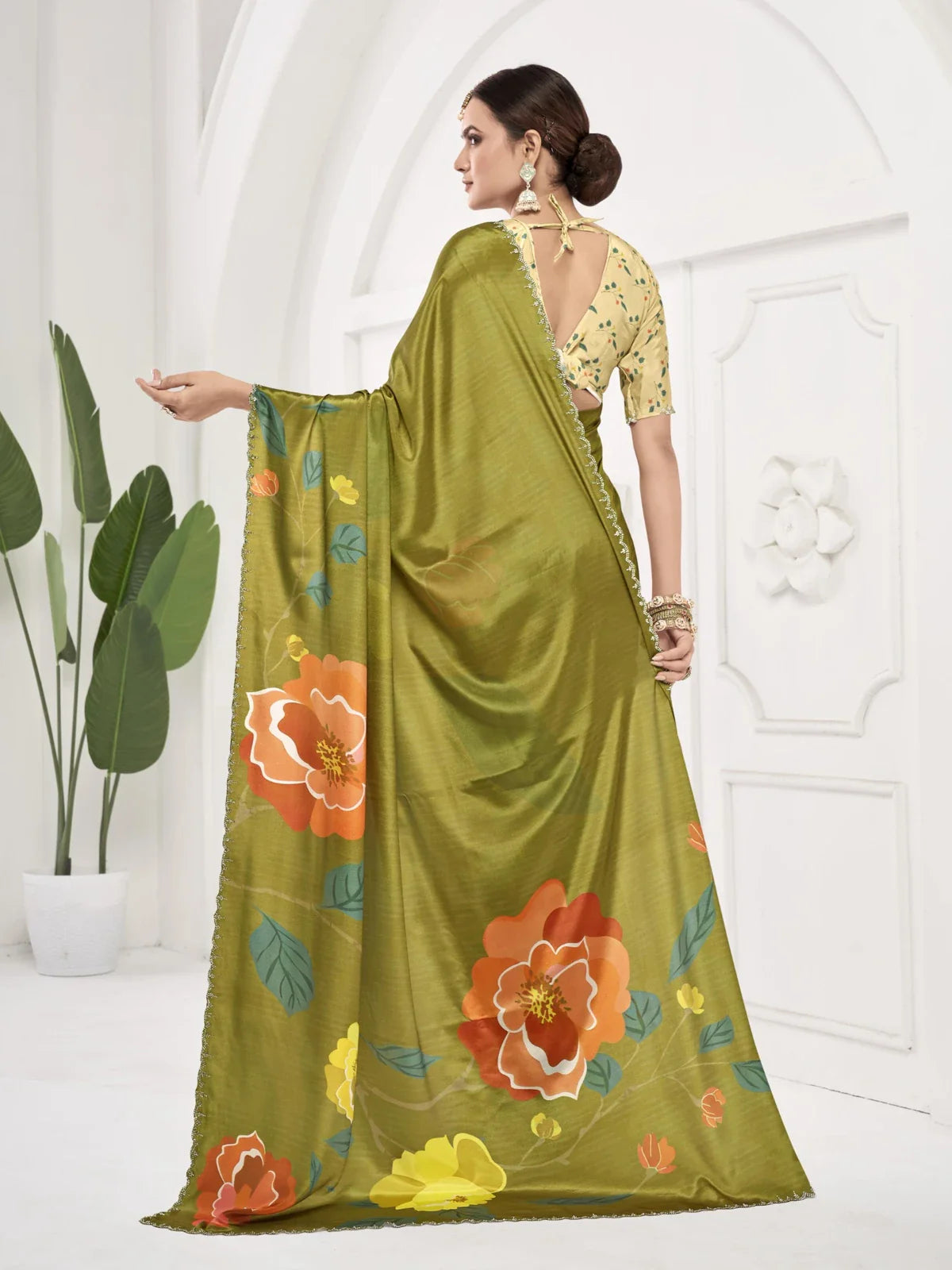 Tarani green saree with back fall and pallu drape showing full blouse and floral pattern