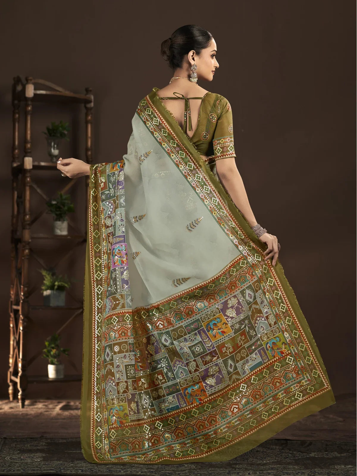 Back view of Tarani green saree with blouse detailing and multicolor printed border drape