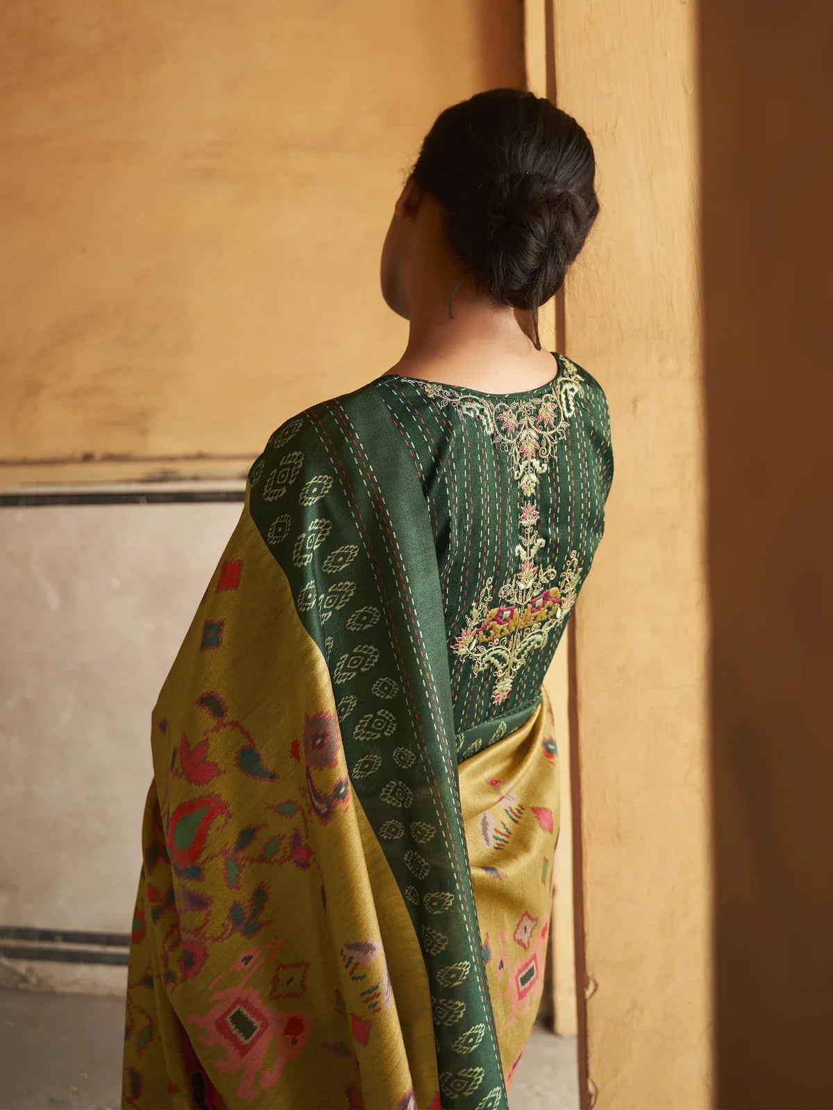 Tarani green blouse view with intricate embroidery paired with tusser silk saree