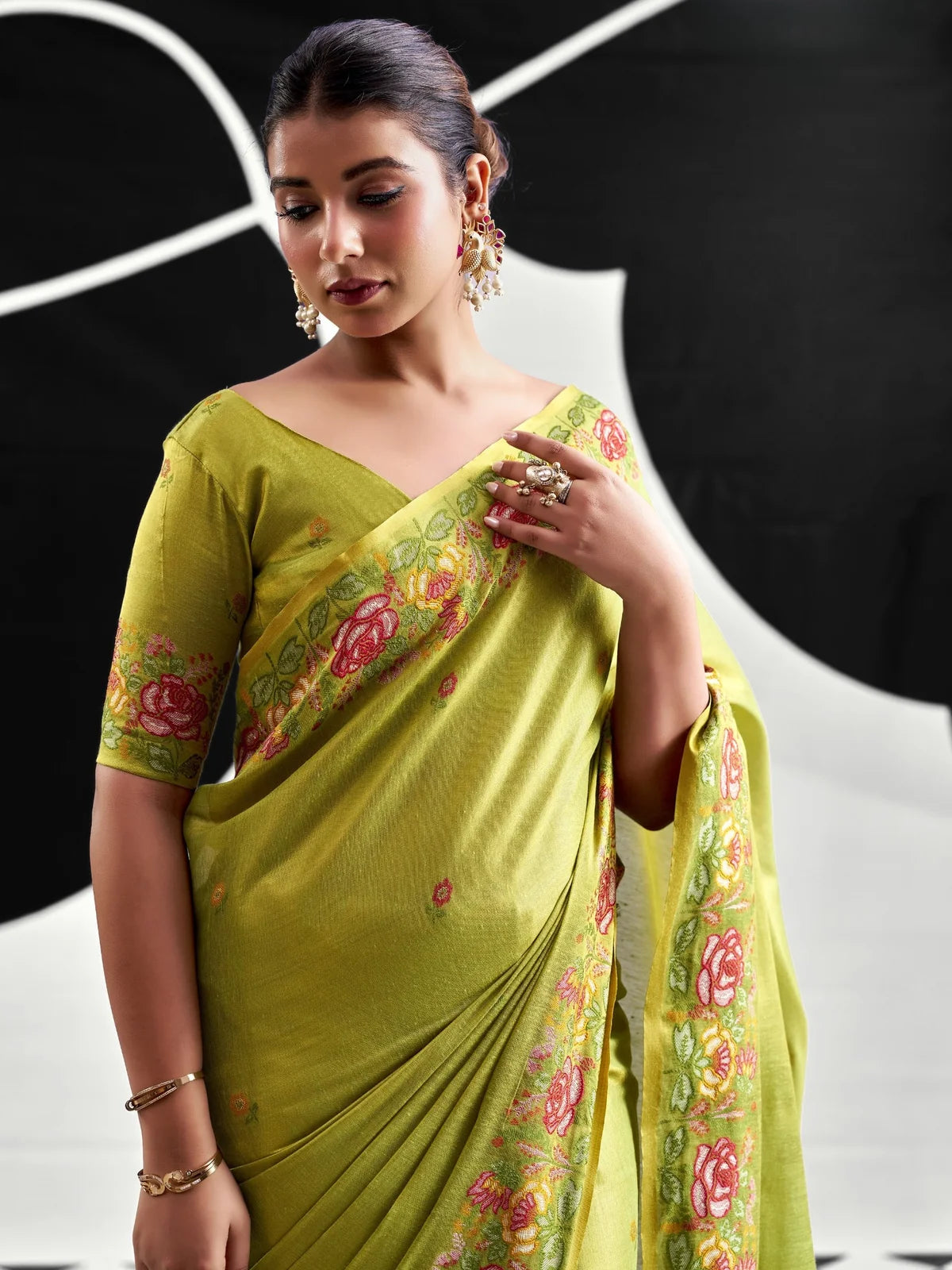 Tarani green tissue silk saree closeup-view with floral woven border and blouse piece