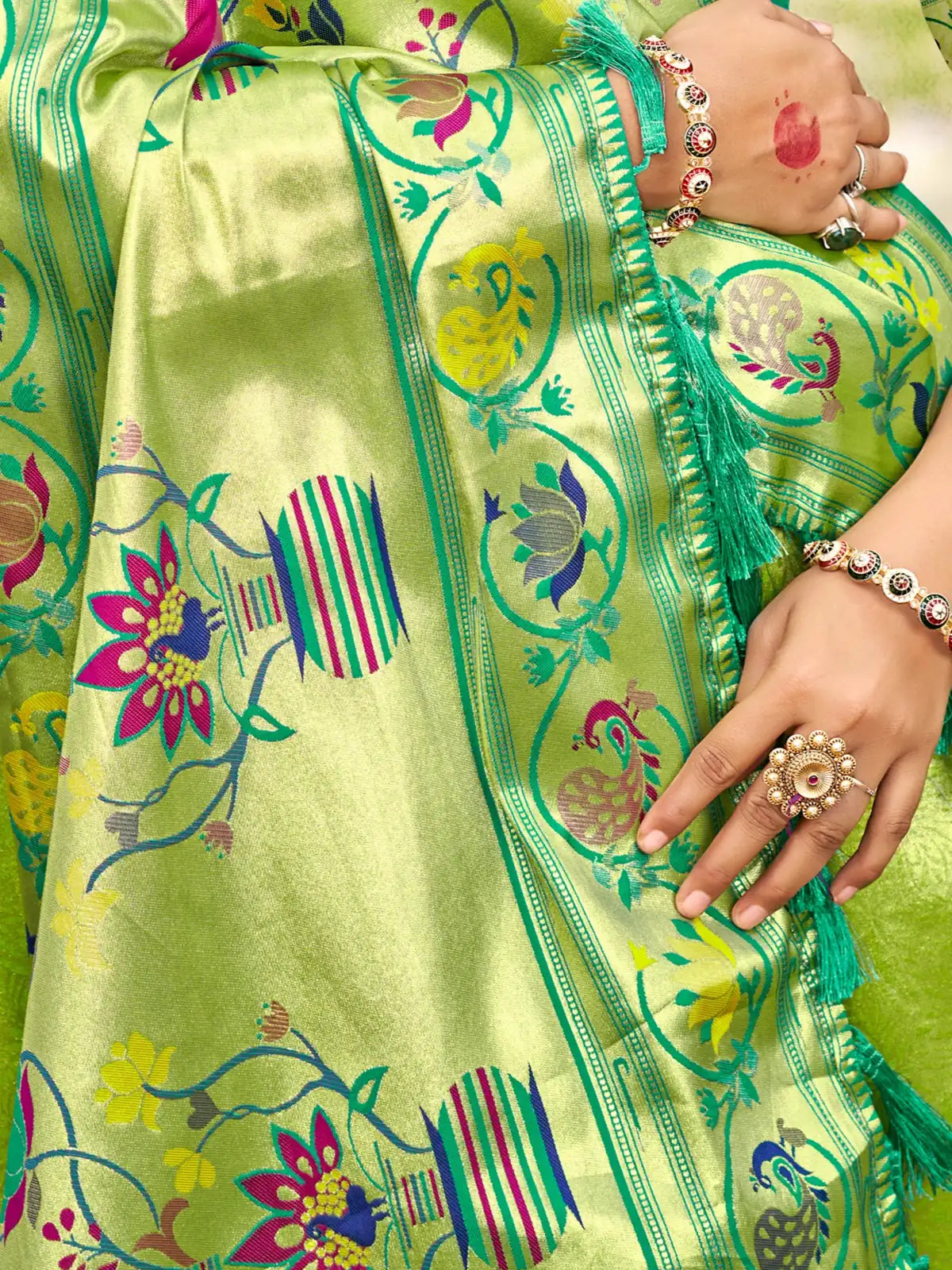 Tarani green Kanjivaram silk saree closeup view highlighting woven motifs border and fabric texture