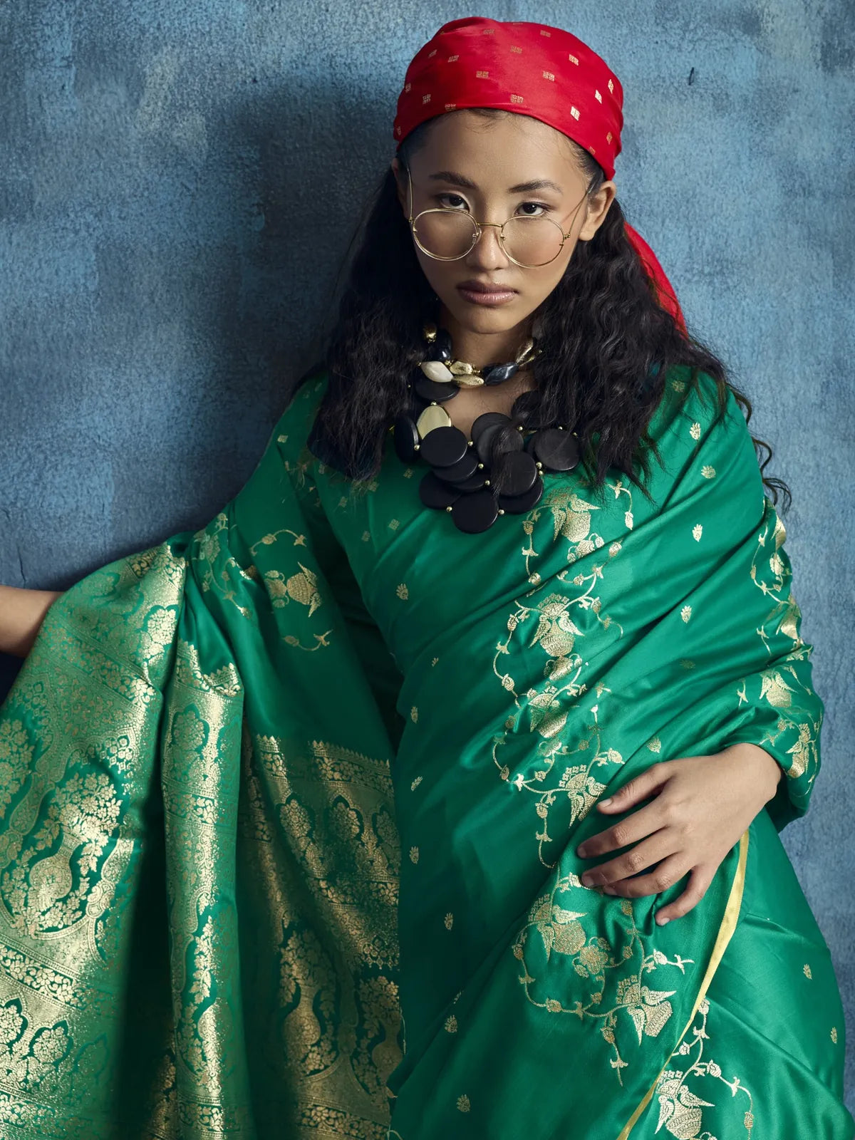 Tarani Rekha closeup view of green satin handloom saree with woven motifs and luxurious pallu