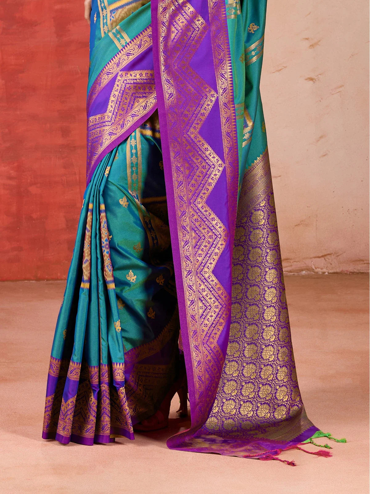Tarani intricate zari work and purple-golden border of green silk saree in close-up view