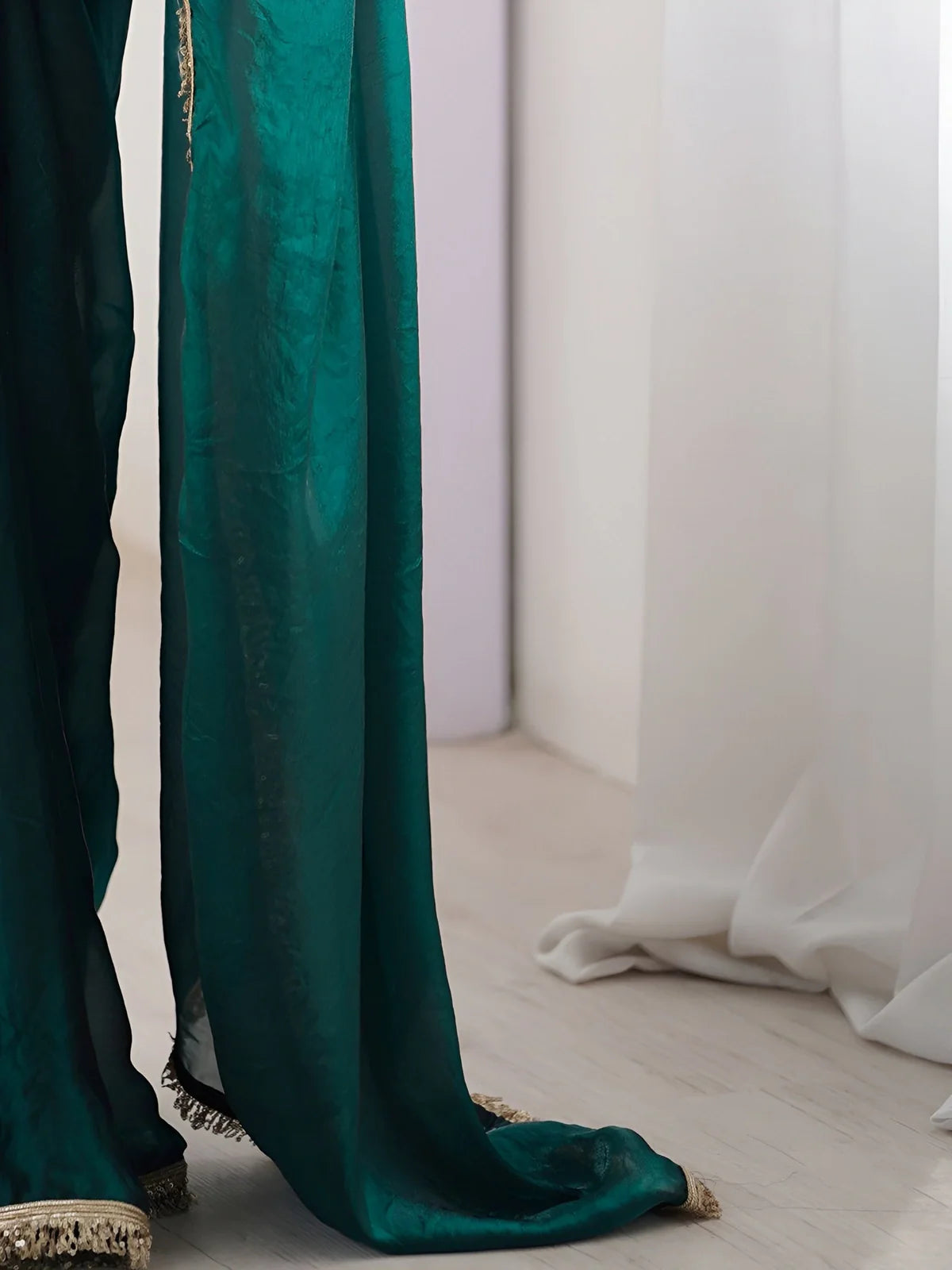 Tarani green soft silk saree closeup showing shimmer fabric and sequin lace border