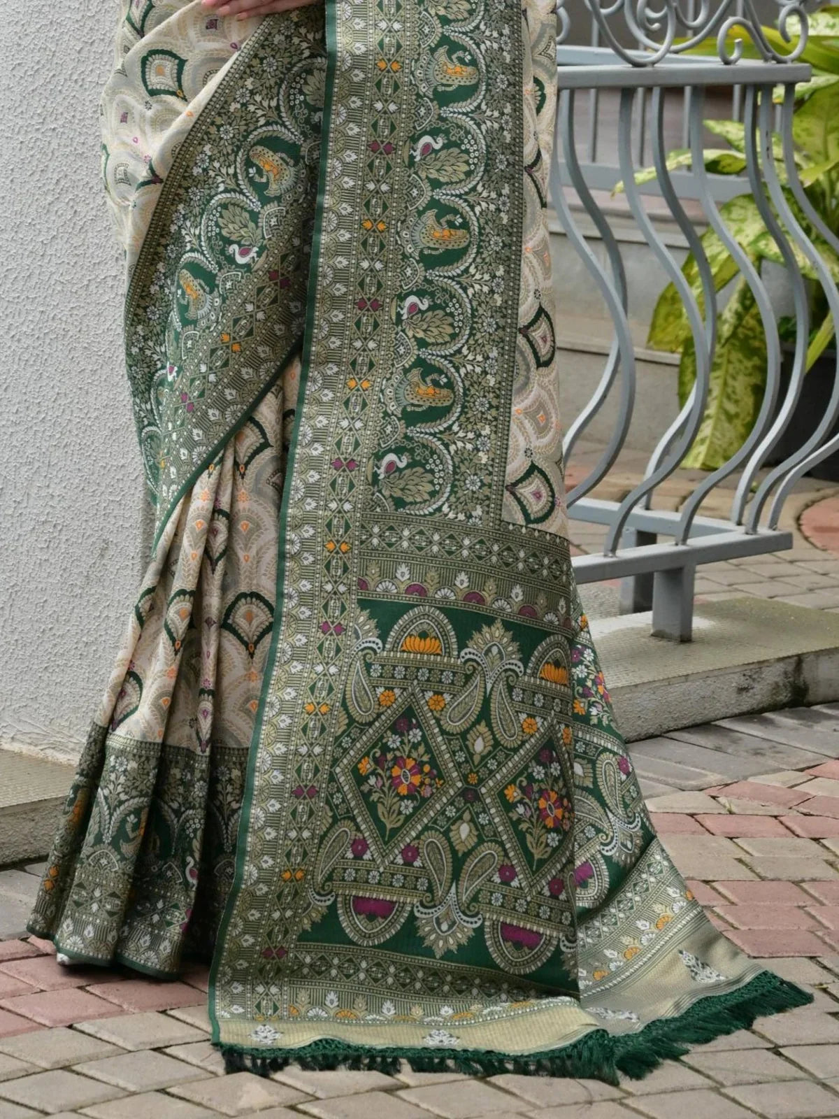 Tarani patola weaving and zari border detailing on green banarasi silk saree
