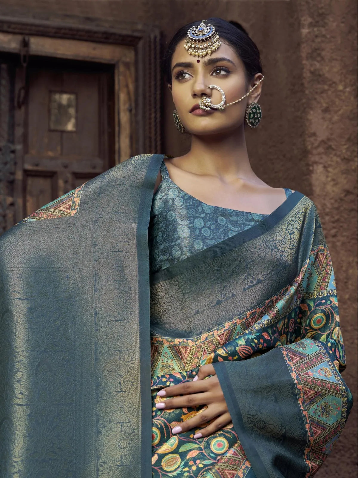 Tarani green silk saree with intricate border and multicolor weaving for traditional occasions