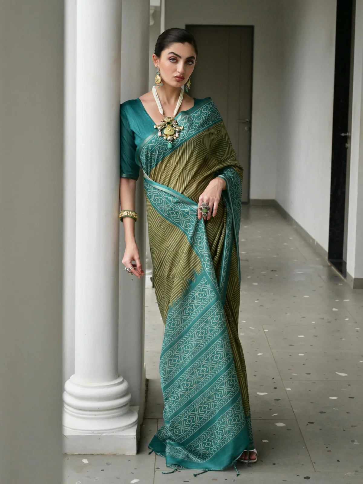 Tarani green tussar silk saree full view with woven geometric patterns and teal pallu border