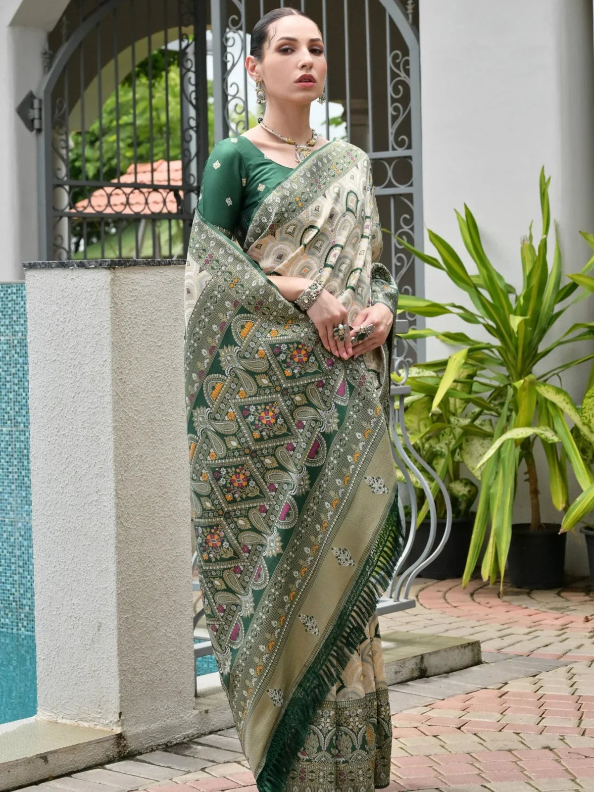Tarani premium green banarasi silk saree full view with zari pallu and patola weaving