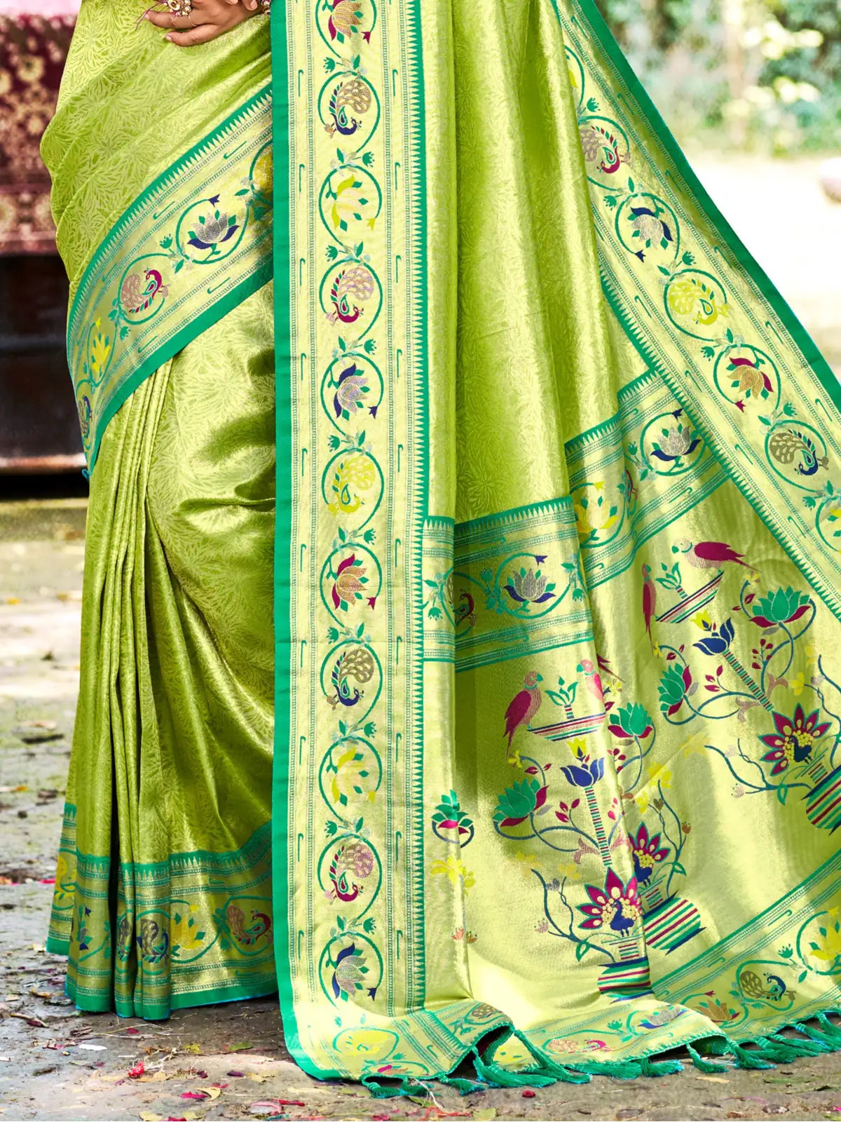 Tarani green Kanjivaram silk saree pallu view with traditional woven Paithani floral and bird motifs