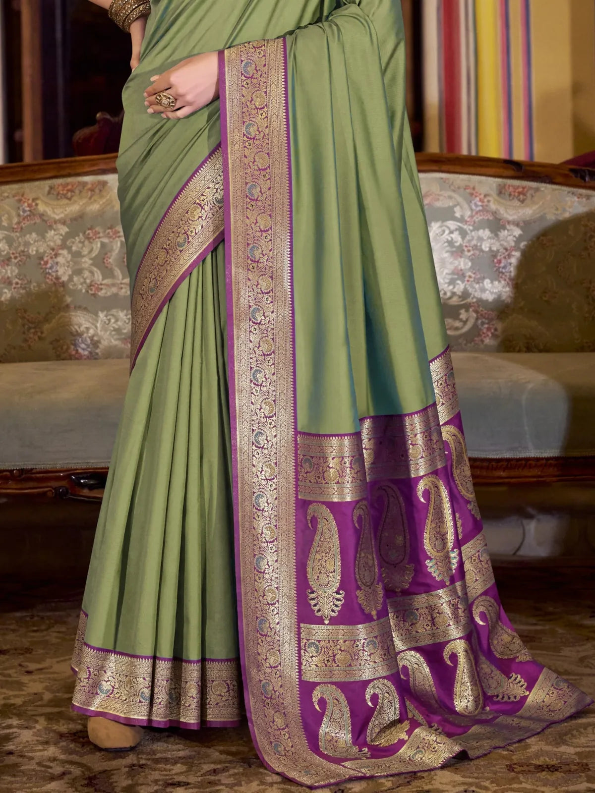 Tarani green silk saree pallu closeup view with intricate golden weaving